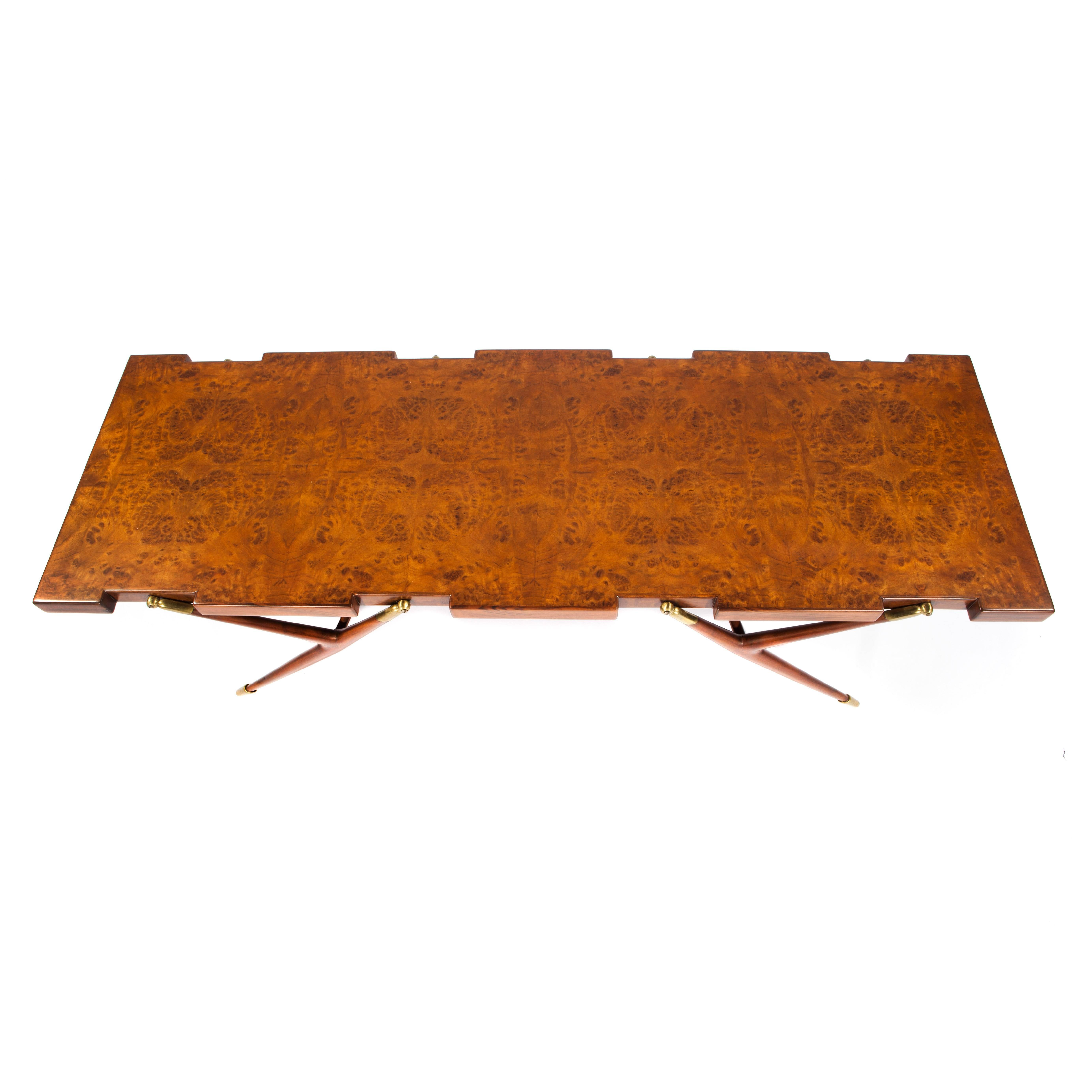 The best of Mid-Century Italian design is reflected in this rare and iconic Ico Parisi coffee table. An excellent example with a gorgeous Italian burled walnut top notched to accommodate four y-shaped walnut legs with brass fittings and feet.