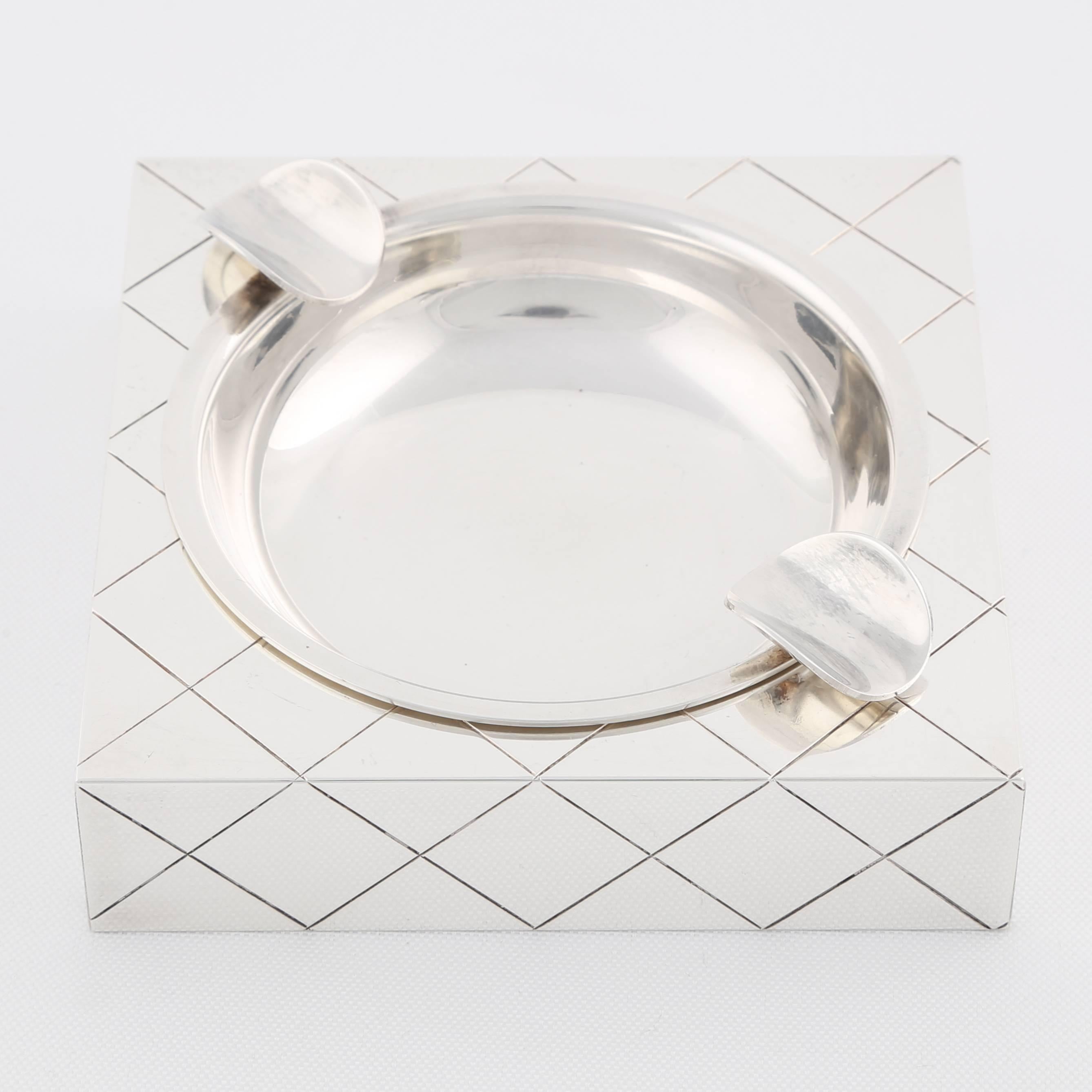 This beautiful silver plated ashtray designed by Tommi Parzinger was part of the Heirloom 700 line of accessories produced under license by Oneida. 