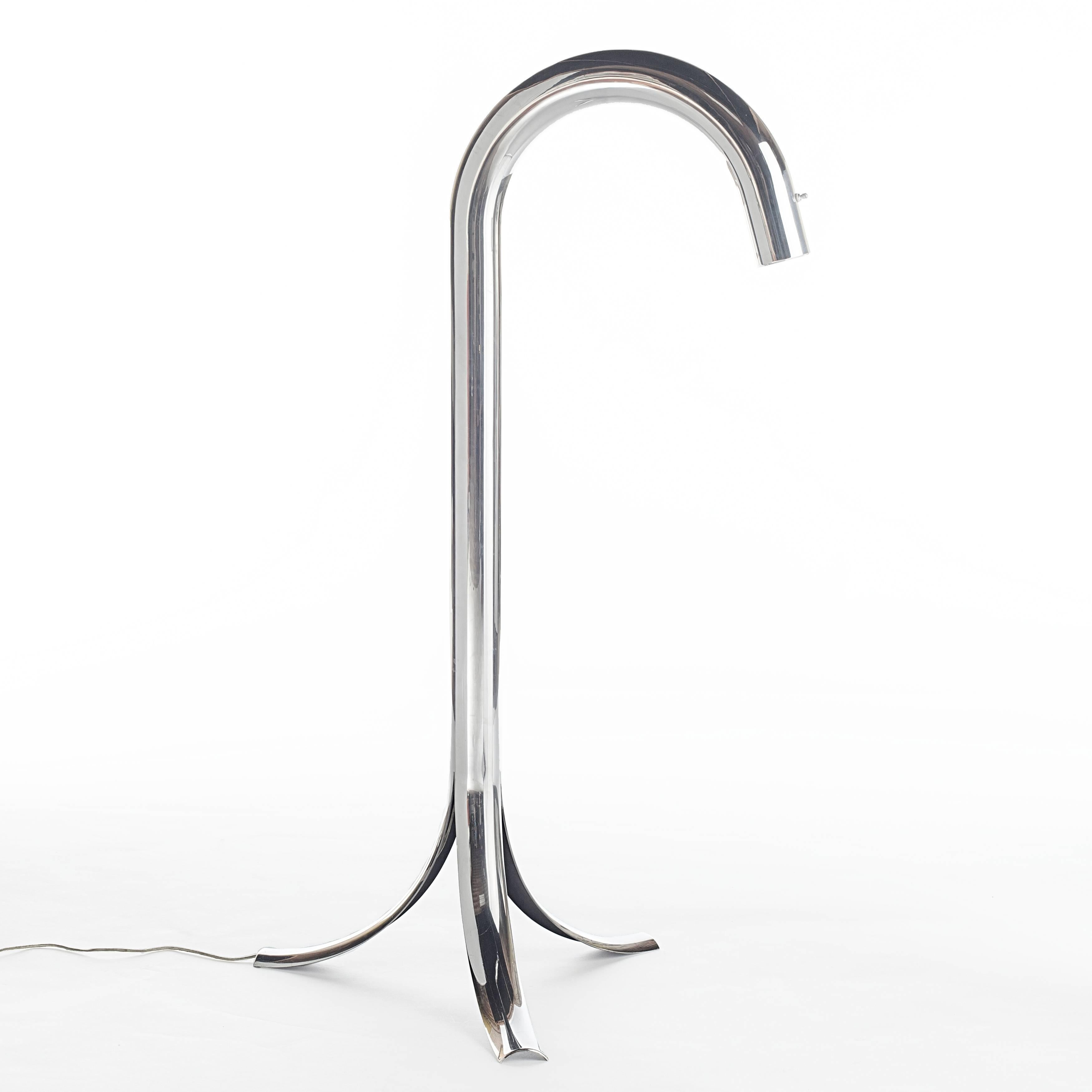 This sculptural aluminum floor lamp is in the permanent collection at MOMA and features three splayed legs merging into a gracefully arched tube. A single switch is located on the neck of the lamp, which takes a single standard-base bulb. 

