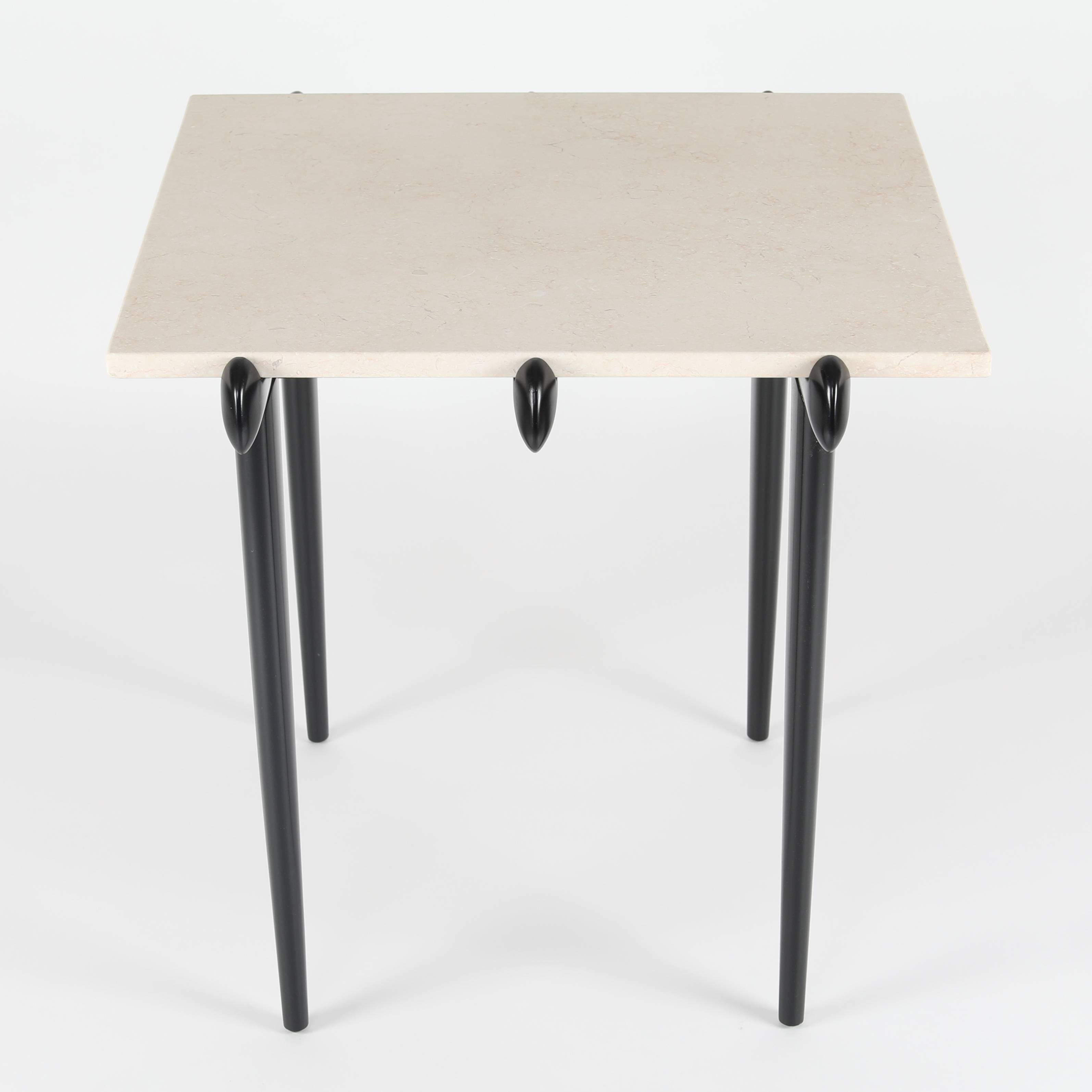 A fine pair of sculptural 1950s Italian end tables featuring four tapered legs leading to six 