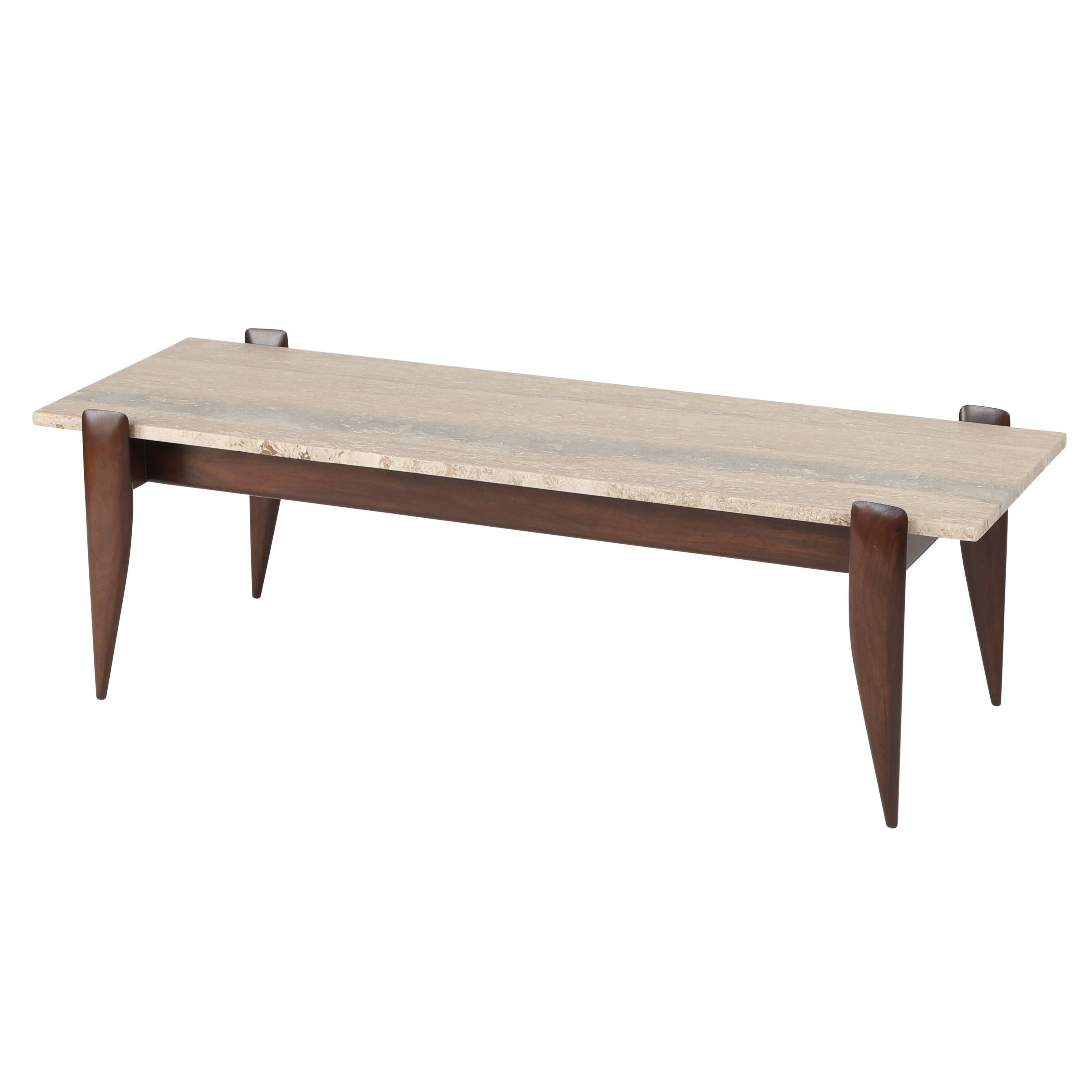 This simple but elegant 1950s Gio Ponti coffee table has a warm-brown walnut frame with four sculpted and tapered legs that hold in place the 3/4