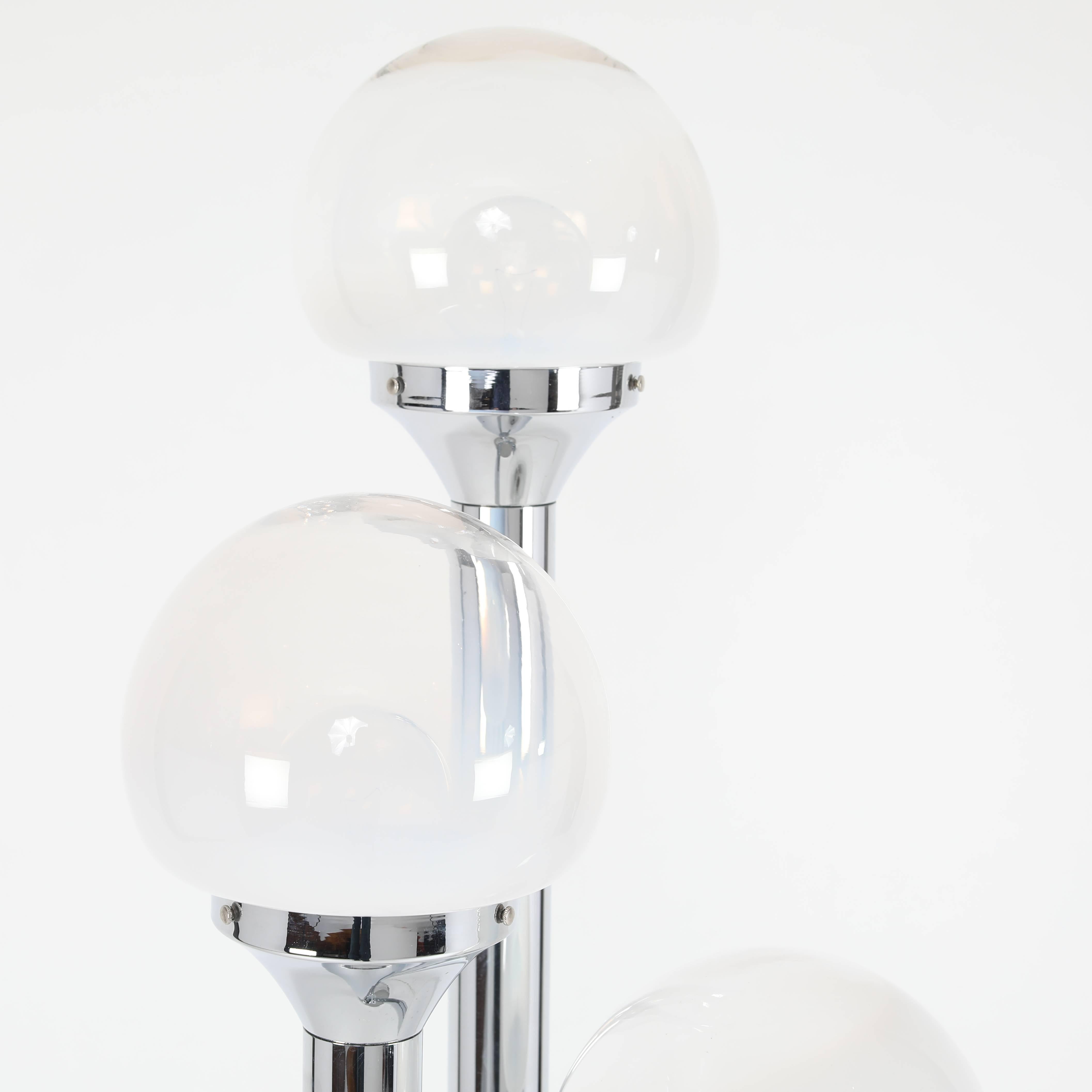 Polished-chrome floor lamp with three tubular supports, each holding a Murano-glass globe that is solid white at the base graduating to clear at the top. A foot switch is located in the middle of the round base. Uses three standard-base bulbs.