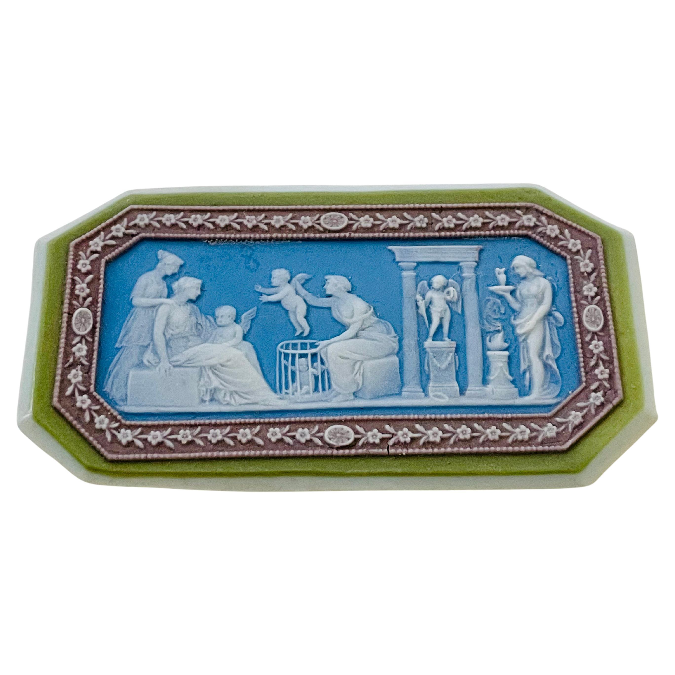 Etruria, Staffordshire, c. 1790, octagonal wafer-thin white jasper with green jasper dip framing, lilac ground boarder with white jasper floral meander, central decoration with blue dip ground, white sprigging depicting Sacrifice to Eros and Sale of