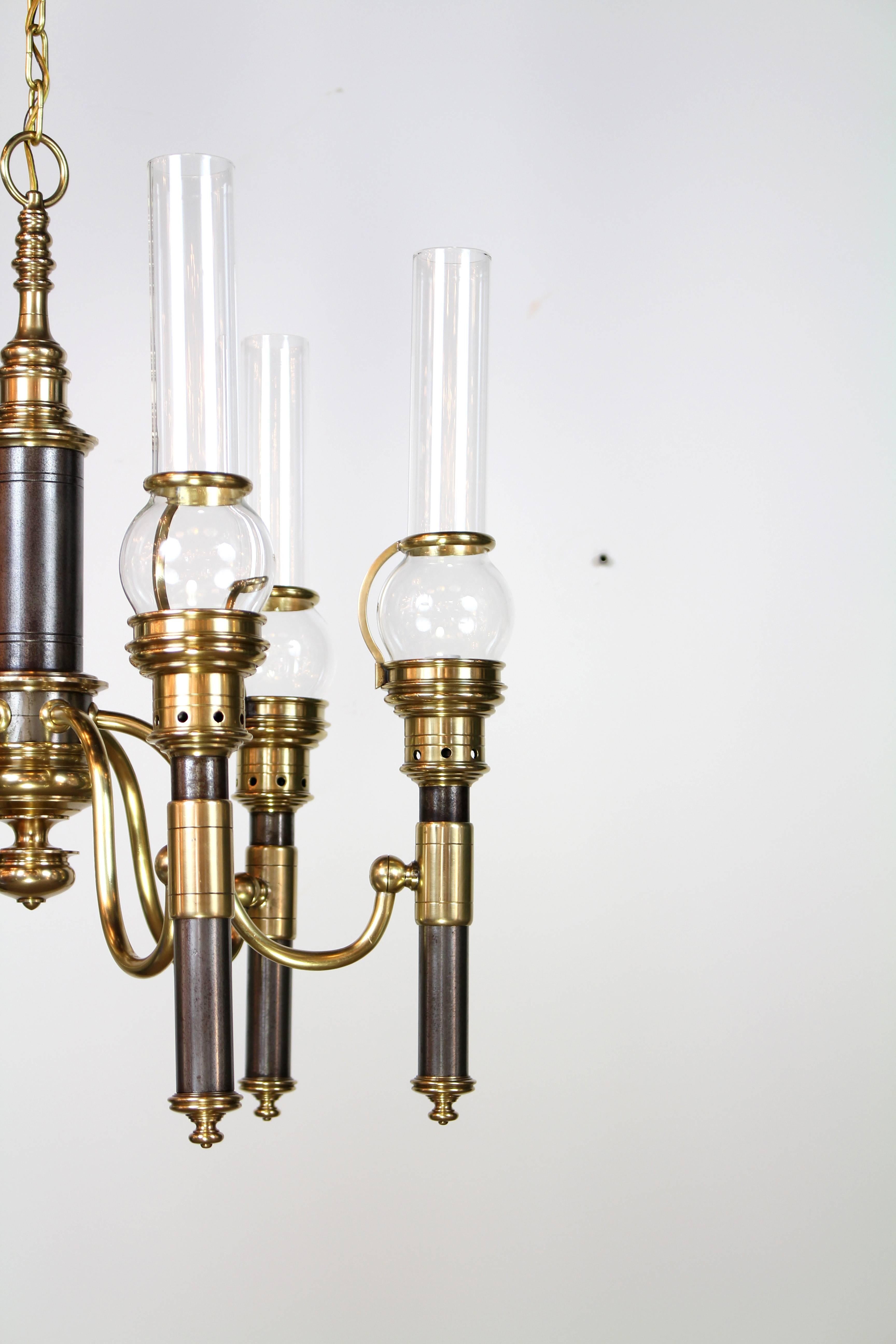 Chapman railroad style chandelier with six arms and glass chimneys. Two-tone steel and brass finish. The height listed is the minimum total drop with chain and canopy, chandelier itself is 25