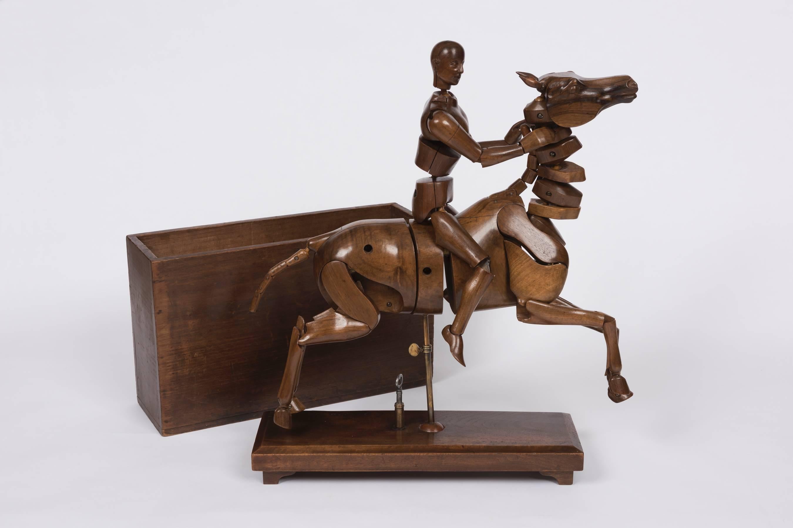 A 1900s figured walnut articulated artists horse and rider lay figure by Lechertier Barbe 93 Jermyn Street London. Together with original packing box. The figure is fully articulated, the rider detachable.
Lechertier Barbe were known for producing