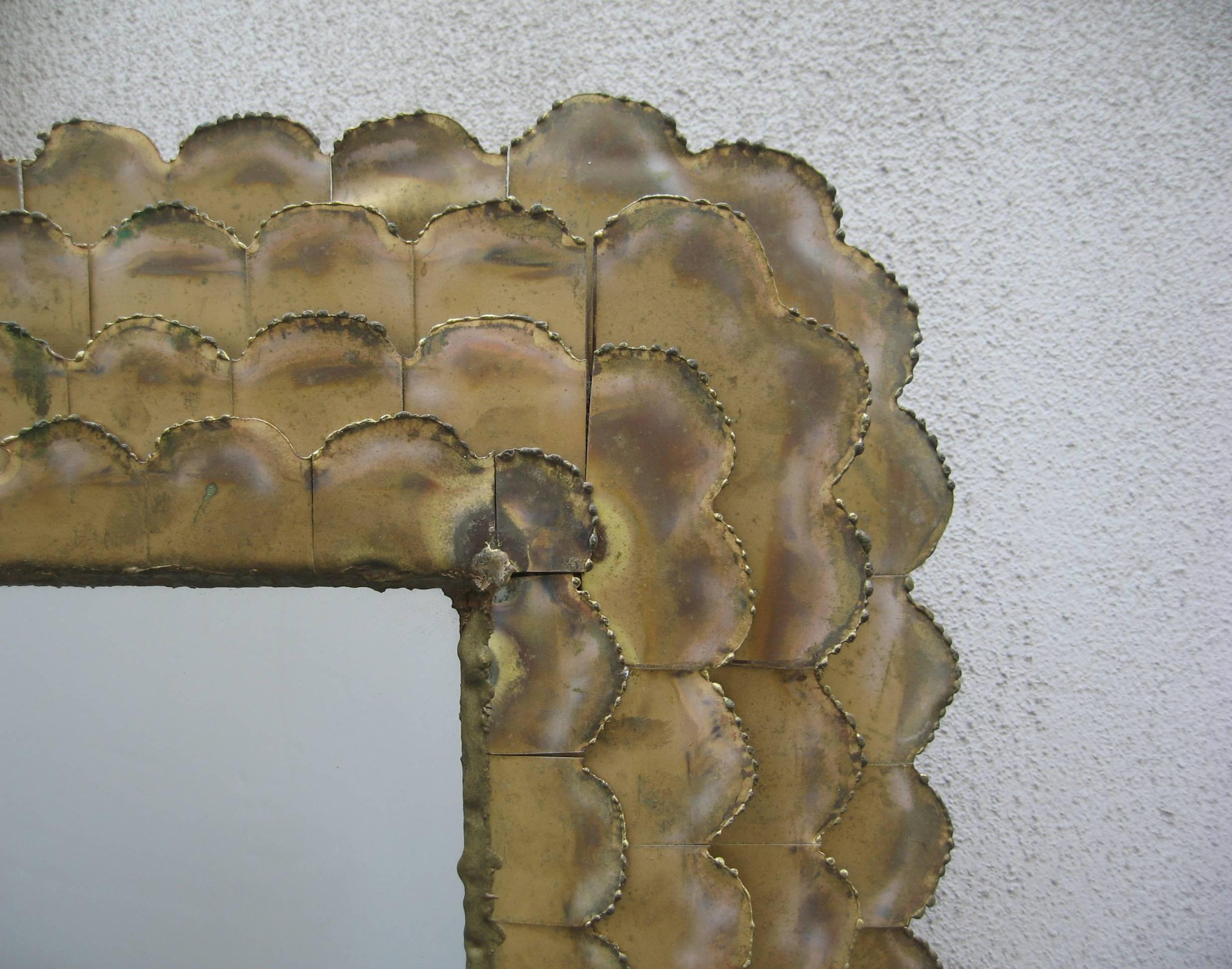 A Curtis Jere designed modernist mirror
with four layers of scalloped metal profiles.
Signed: C. Jere.