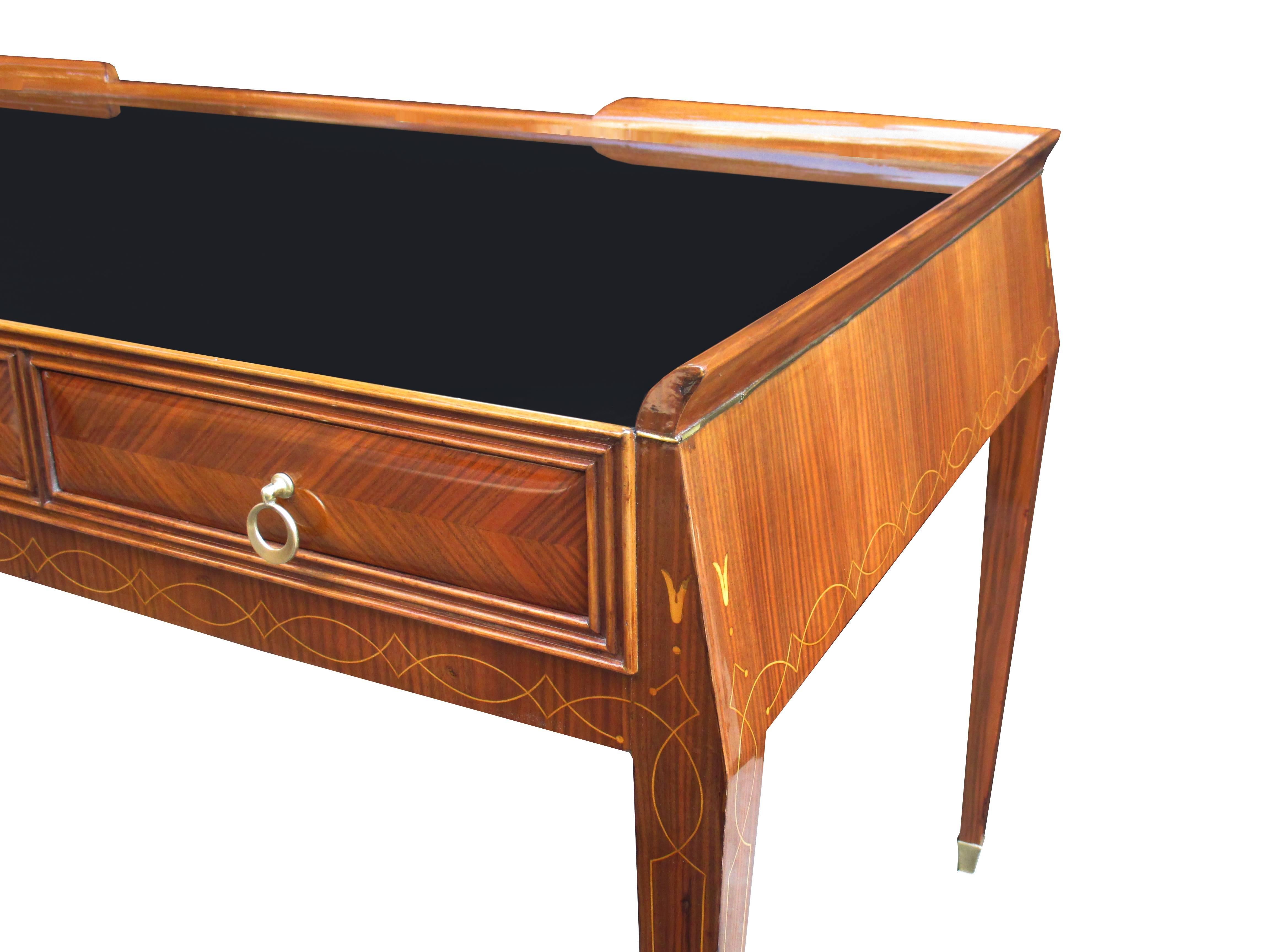 A fine modernist desk with glass top
designed by Paolo Buffa. Palisander with marquetry patterned drawer fronts, 
fruitwood inlays and patinated bronze pulls and sabots. Featuring a black glass writing surface.