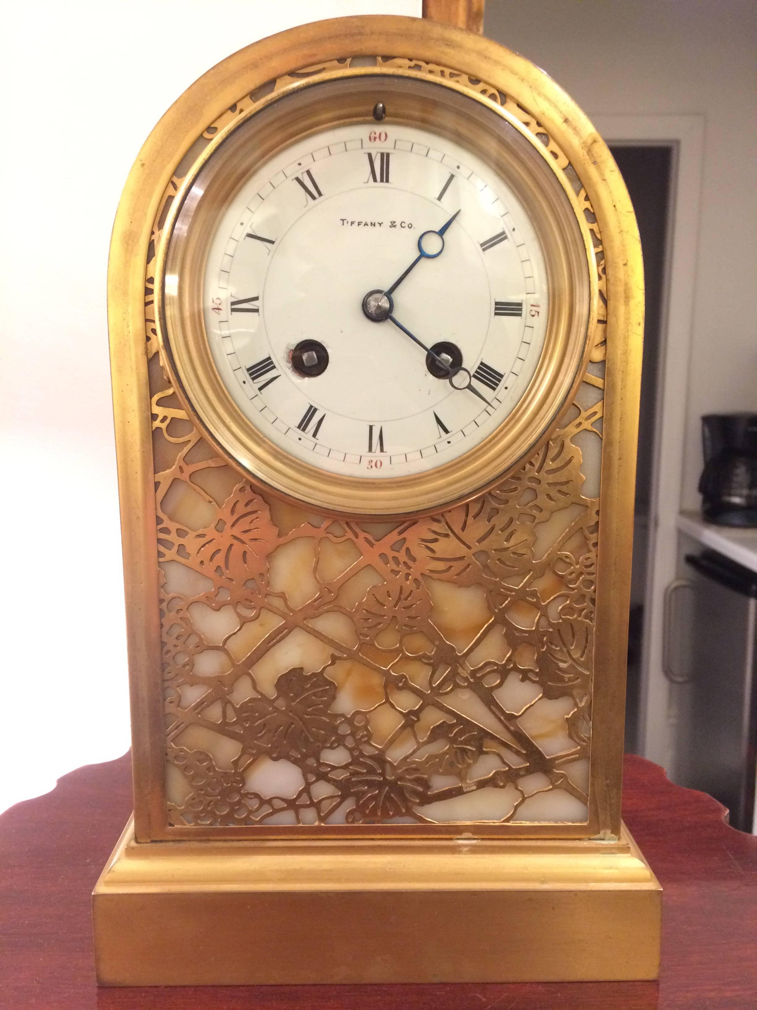 A fine Tiffany Studios Art Nouveau clock.
Grapevine pattern gilt bronze over caramel favrile glass case.
Case marked Tiffany Studios, New York, 879. Porcelain dial marked Tiffany & Co., Roman numerals with red Arabic numerals at the quarter hour.