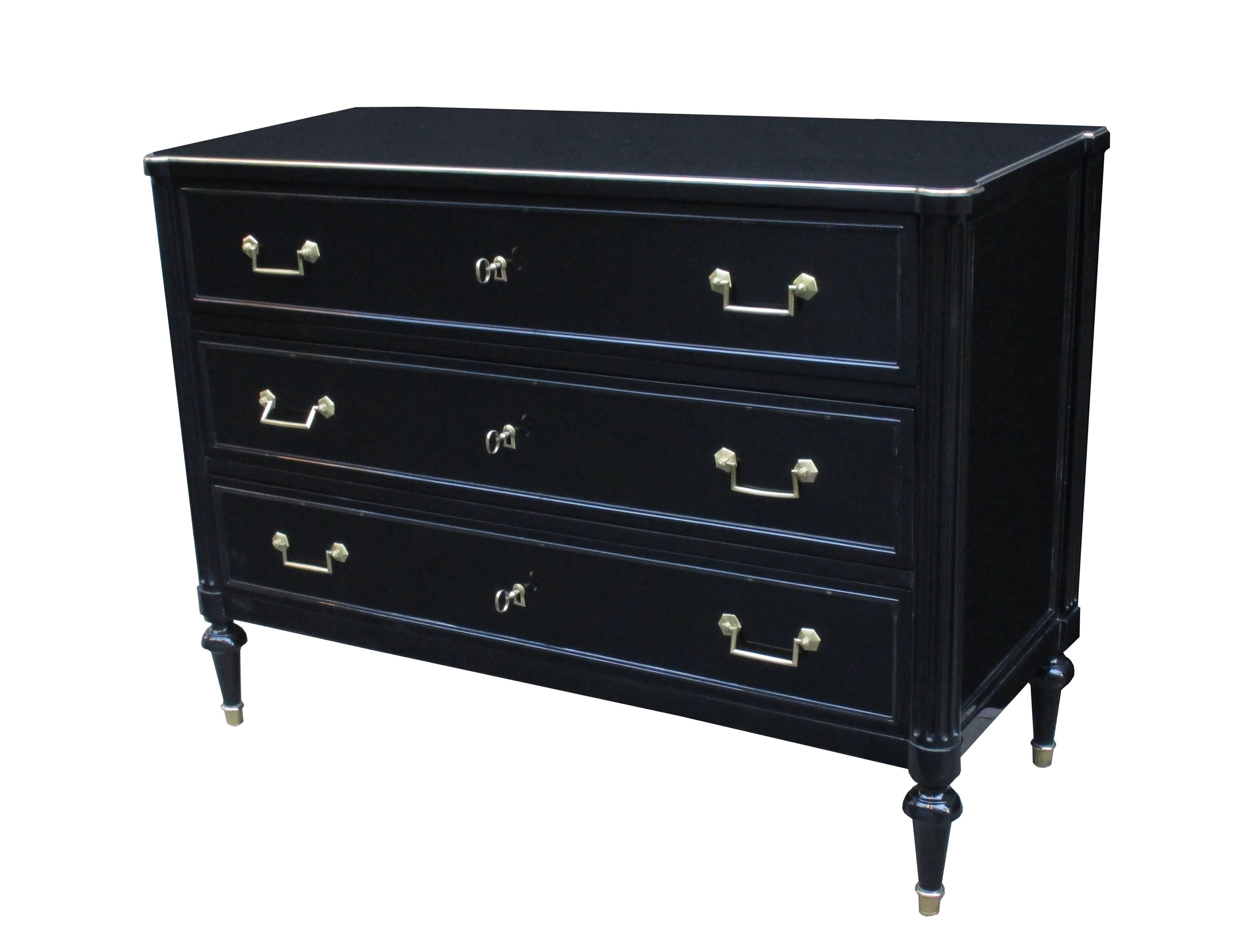 A fine pair of neoclassical three-drawer commodes.
Black lacquer with fluted column details and patinated bronze pulls, sabots, escutcheons and details.
 