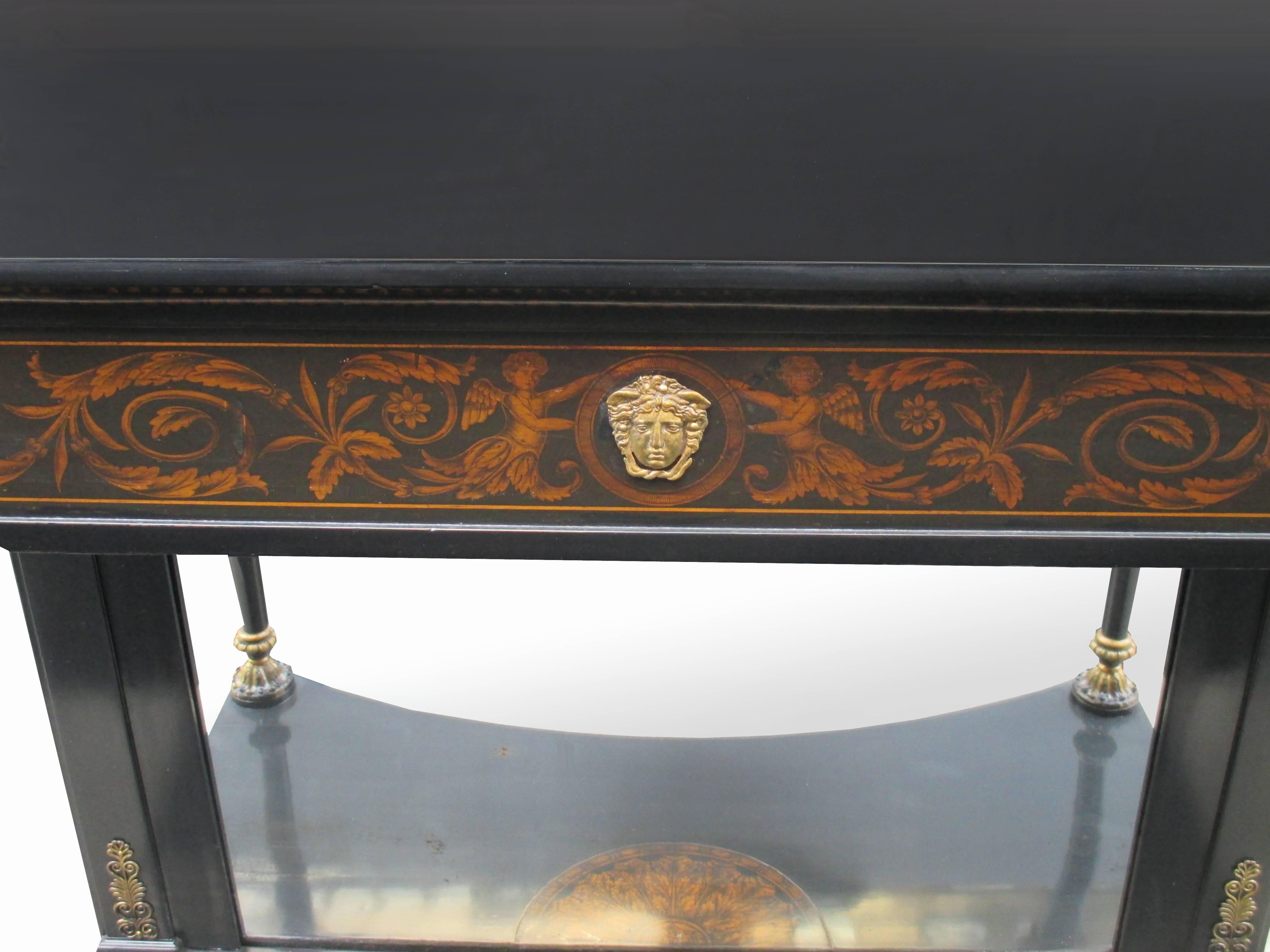 A fine ebonized Empire colsole.
Ebonized pearwood with fine penwork details,
carved giltwood details, and mirrored back panel.

Full restoration by Karl Kemp antiques.