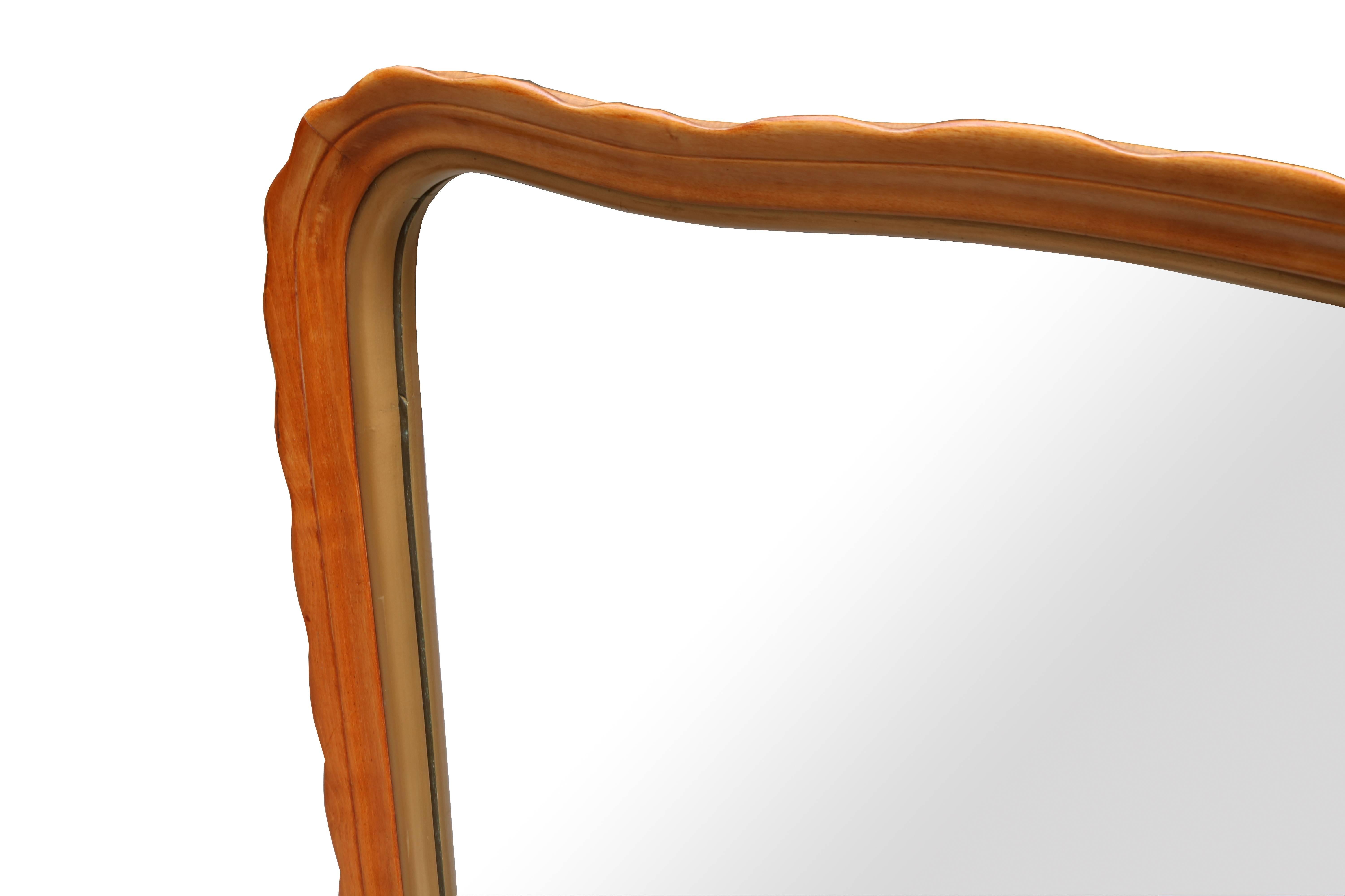 An Italian modernist mirror.
Solid fruitwood with inner giltwood trim.

        