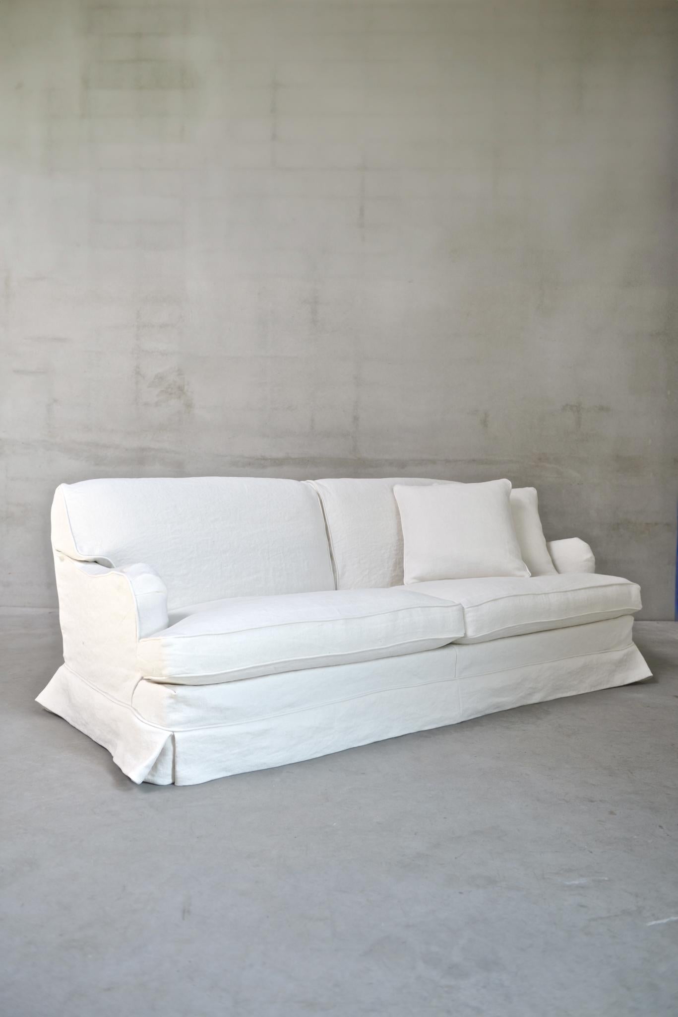 The Boulbon Sofa by am designs combines relaxed elegance with practical versatility. Handmade in Belgium with a solid wooden frame, it features a durable construction and plush seat and back cushions for exceptional comfort. The fully removable