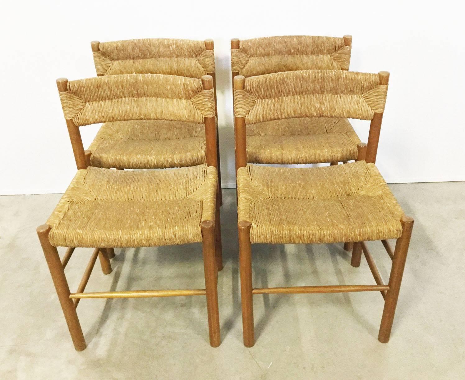 Four chairs with straw seat and back, legs in thick pinewood.
Designed by Robert Sentou