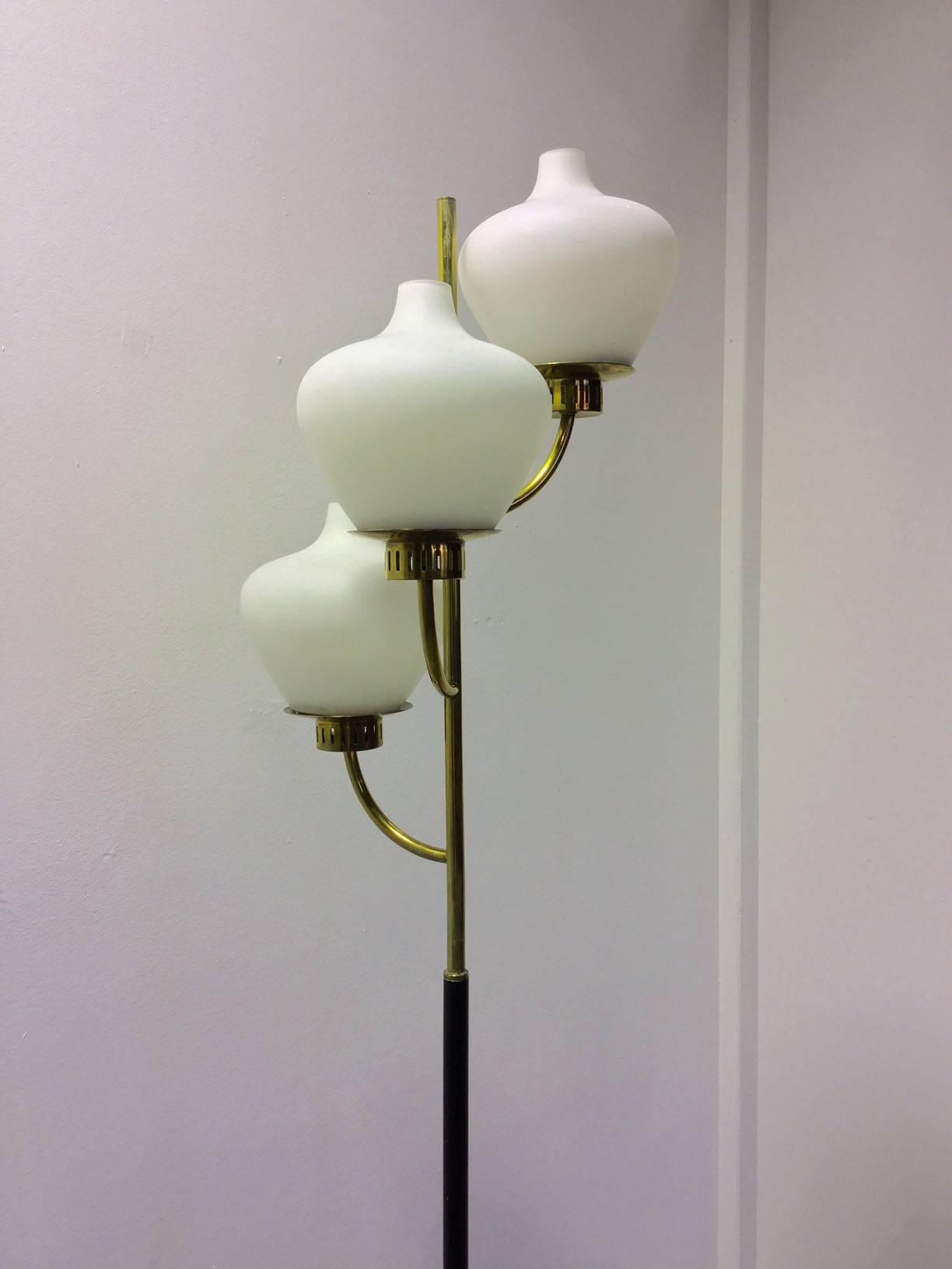 Very nice floor lamp with marble base and black metal stem surmounted by three brass arms with white opaline globe as diffusers.
Wire system is functioning.
Made in Italy by Stilnovo in 1950, label on the structure.