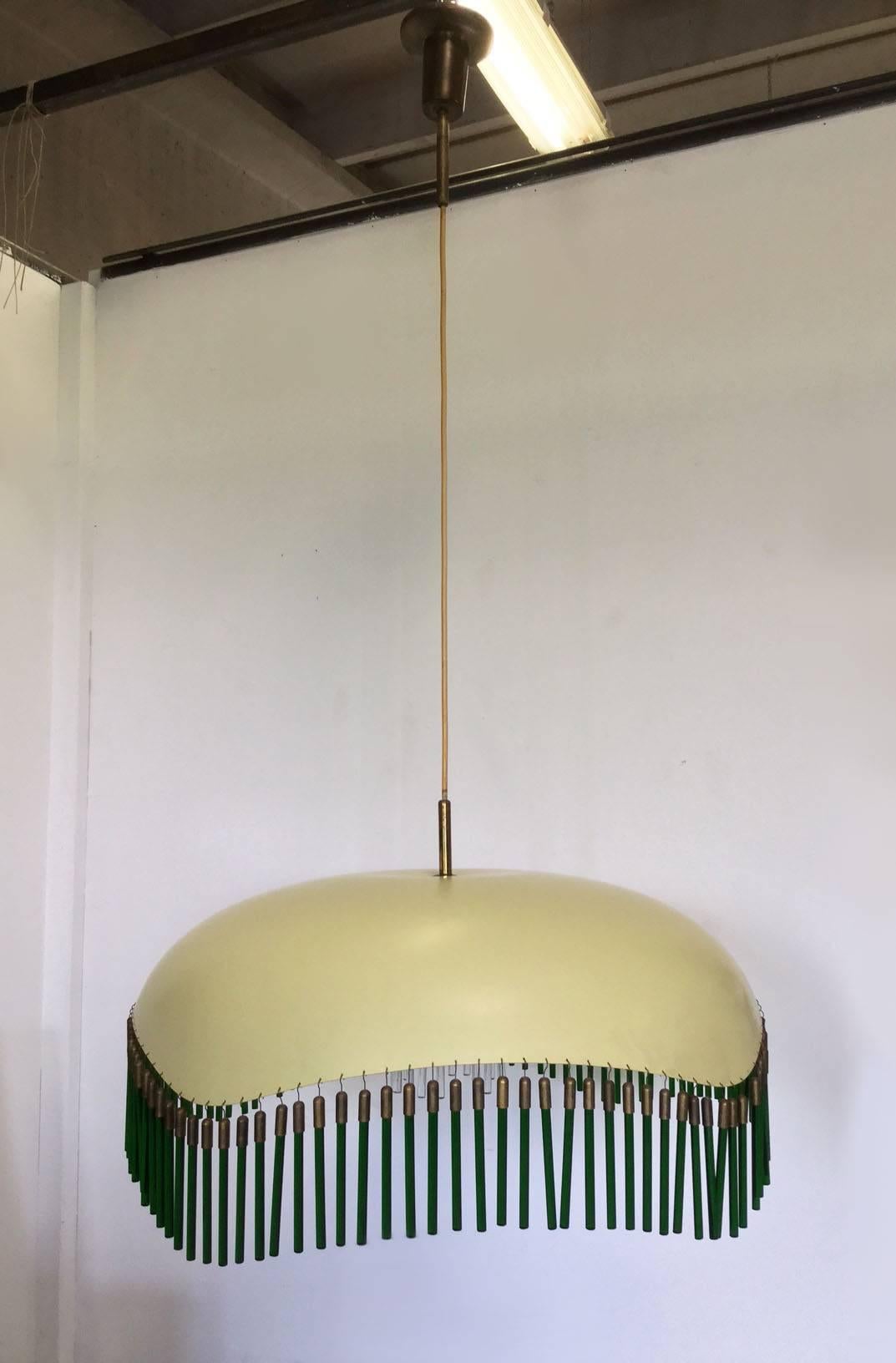 Beautiful chandelier by Arredoluce made in 1950, yellow lacquered metal cup with green glass pendants at the edges. 
Inside the cup there is another diffuser cylindrical shaped white lacquered with white glass pendants. 
Cylindrical brass to hang