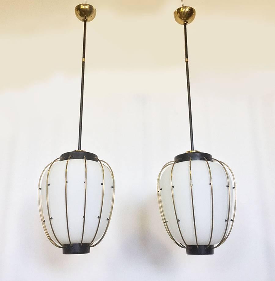 Beautiful chandeliers with white opaline globe as diffuser, this is surmounted by a brass cage with long black lacquered stem.
Made by Arredoluce in 1950.

