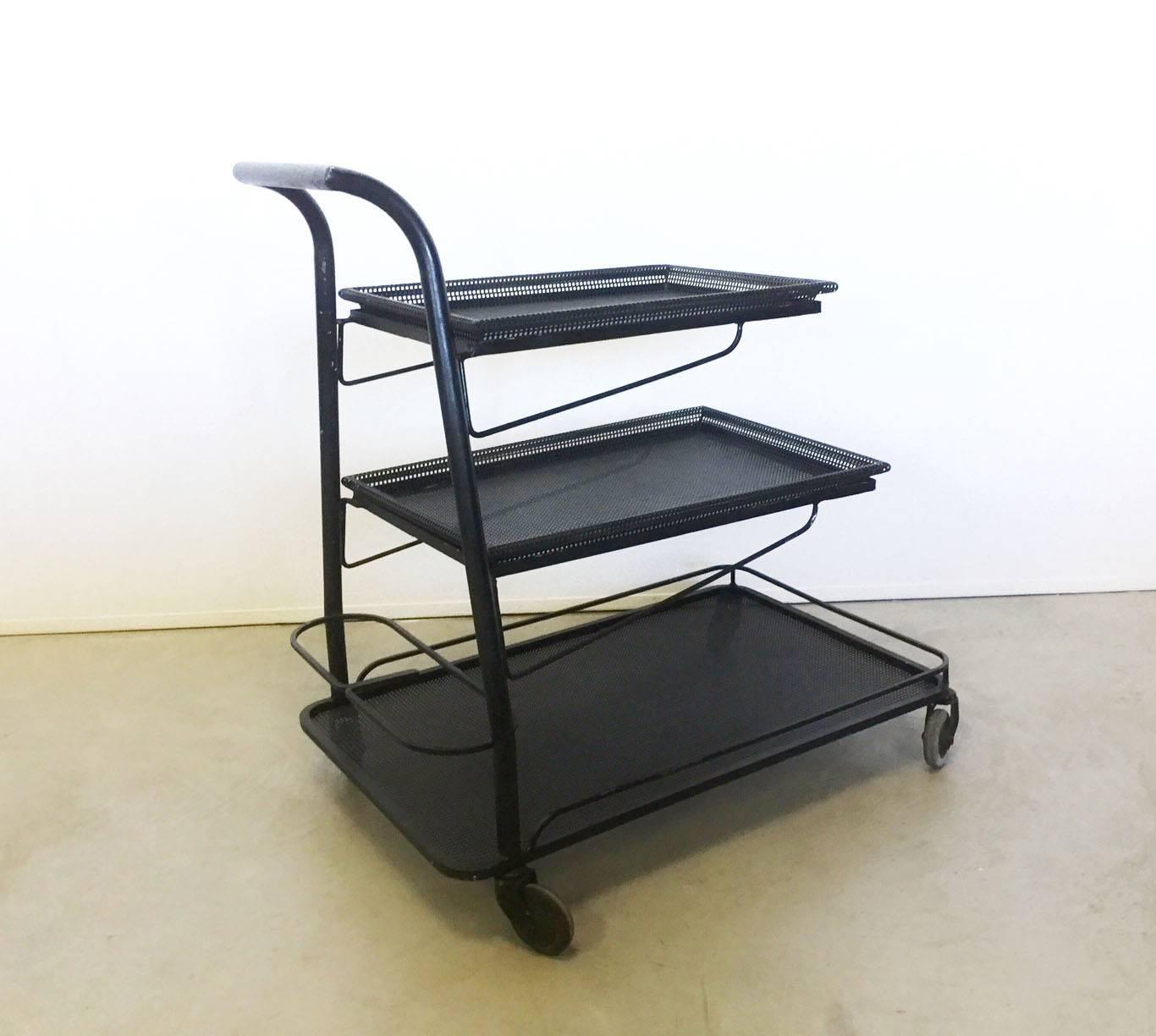 Exceptional cart designed by M. Mategot in 1950, three removable shelves in perforated sheet with iron black lacquered frame, wheels as final.
Iconic and forerunner of time this cart is published into Mategot's catalog of works.