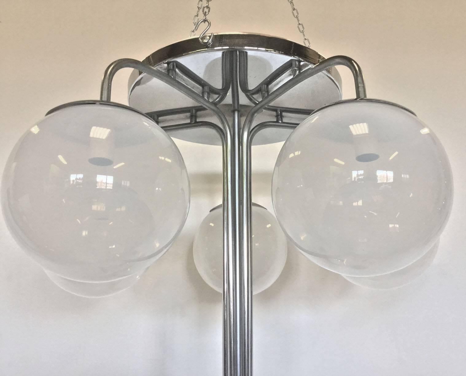 Rare original chandelier designed by A. Mangiarotti for Candle in the 1960s, as the historic catalogue of the company shows us. 
Chrome-plated brass frame with ten transparent shaded glass bowls as diffusers.
 