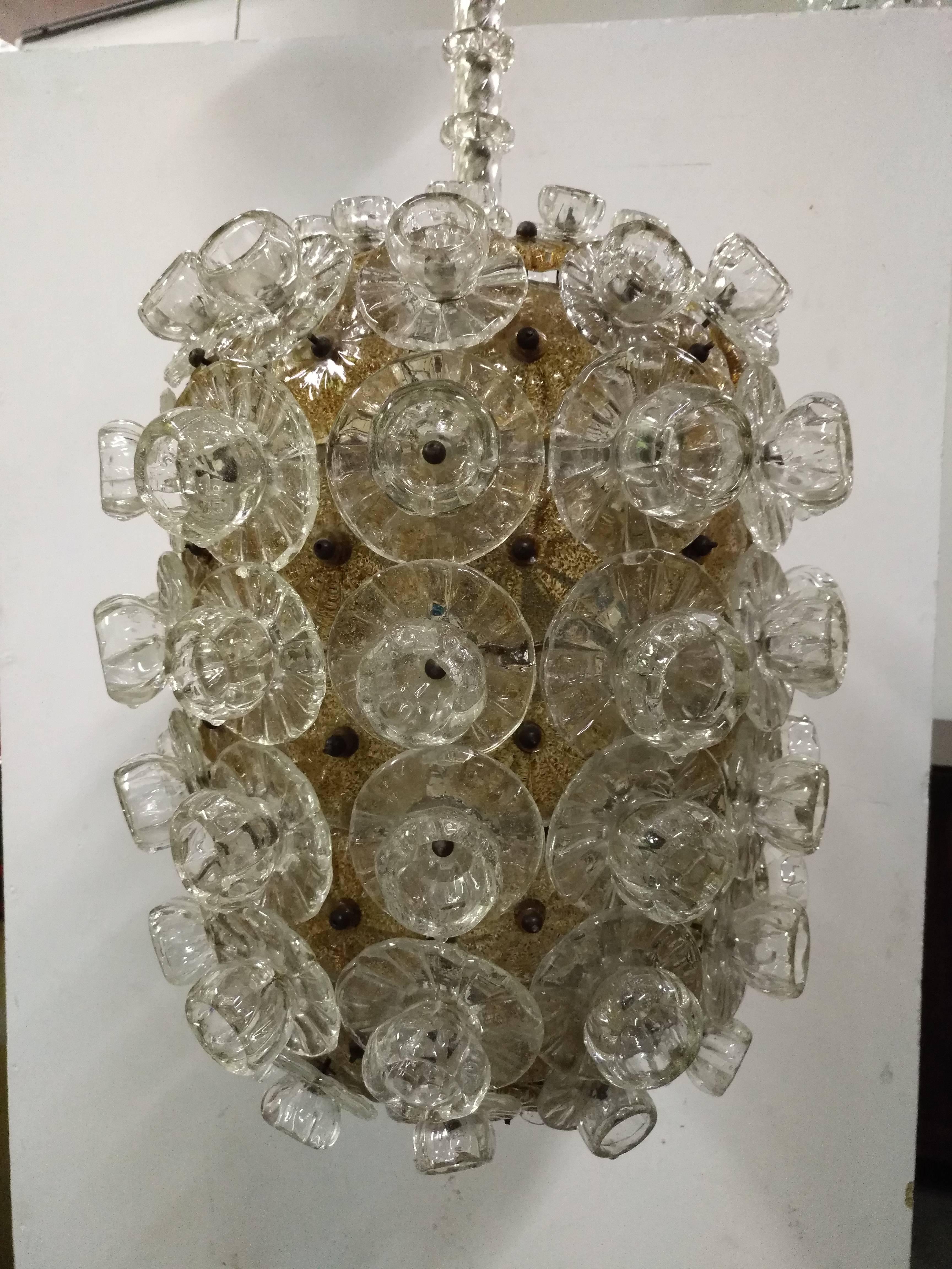 Beautiful chandelier with blown glass plates with flacks of gold and white flowers in different dimensions
Very old and beautiful manufacturing by Barovier Venice, Murano, 1940
Measures: The lantern is cm 65 H.