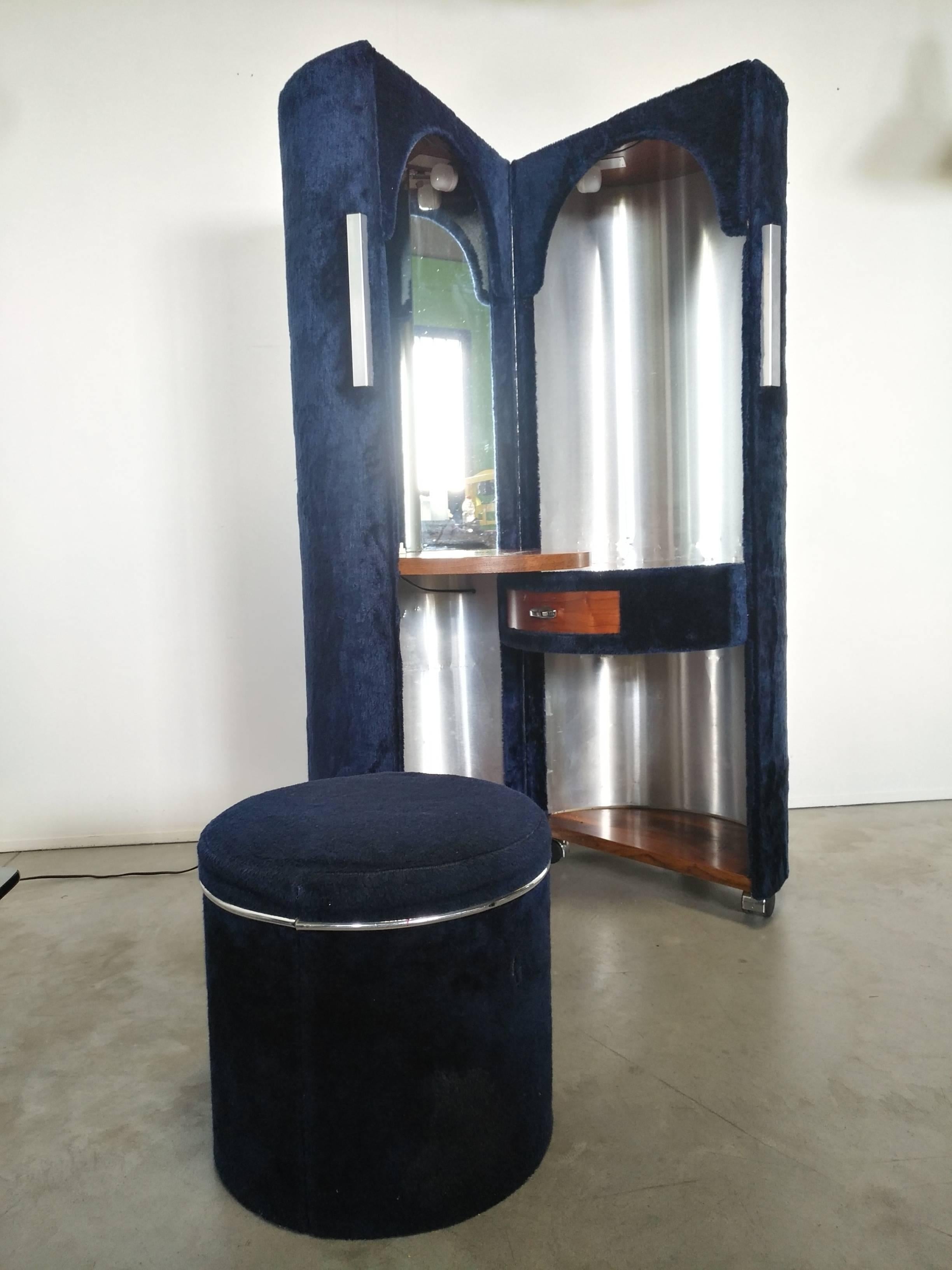 Beautiful openable and swivel room toilet with pouf seat, covered by blue synthetic fur elegant and fashion, inside there are an illuminated mirror and an aluminum coating resting on wood shelfs with a drawers.
This very original object is