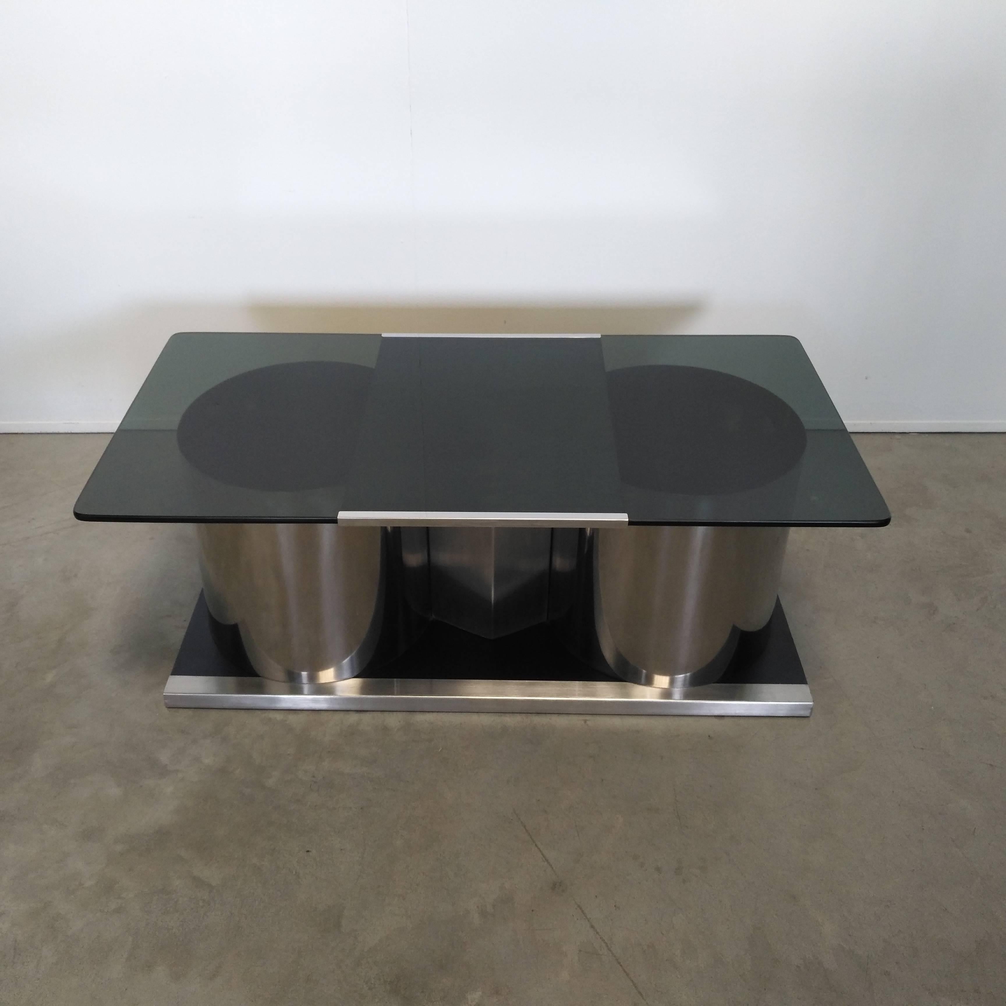 Beautiful coffee table, blue lacquered base with steel columns surmounted by a swivel glass top to hid the bar inside the cylindrical columns, exceptional design and good manufacturing, designed by Francois Monnet in 1970.