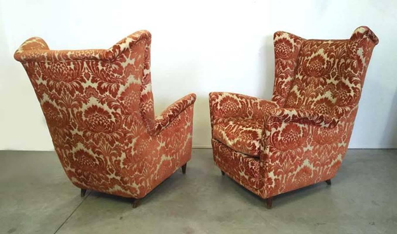 Beautiful velvet wing armchairs designed by Melchiorre Bega in 1950.
Orange damask velvet in very
good condition. 
Wooden cone feet.
