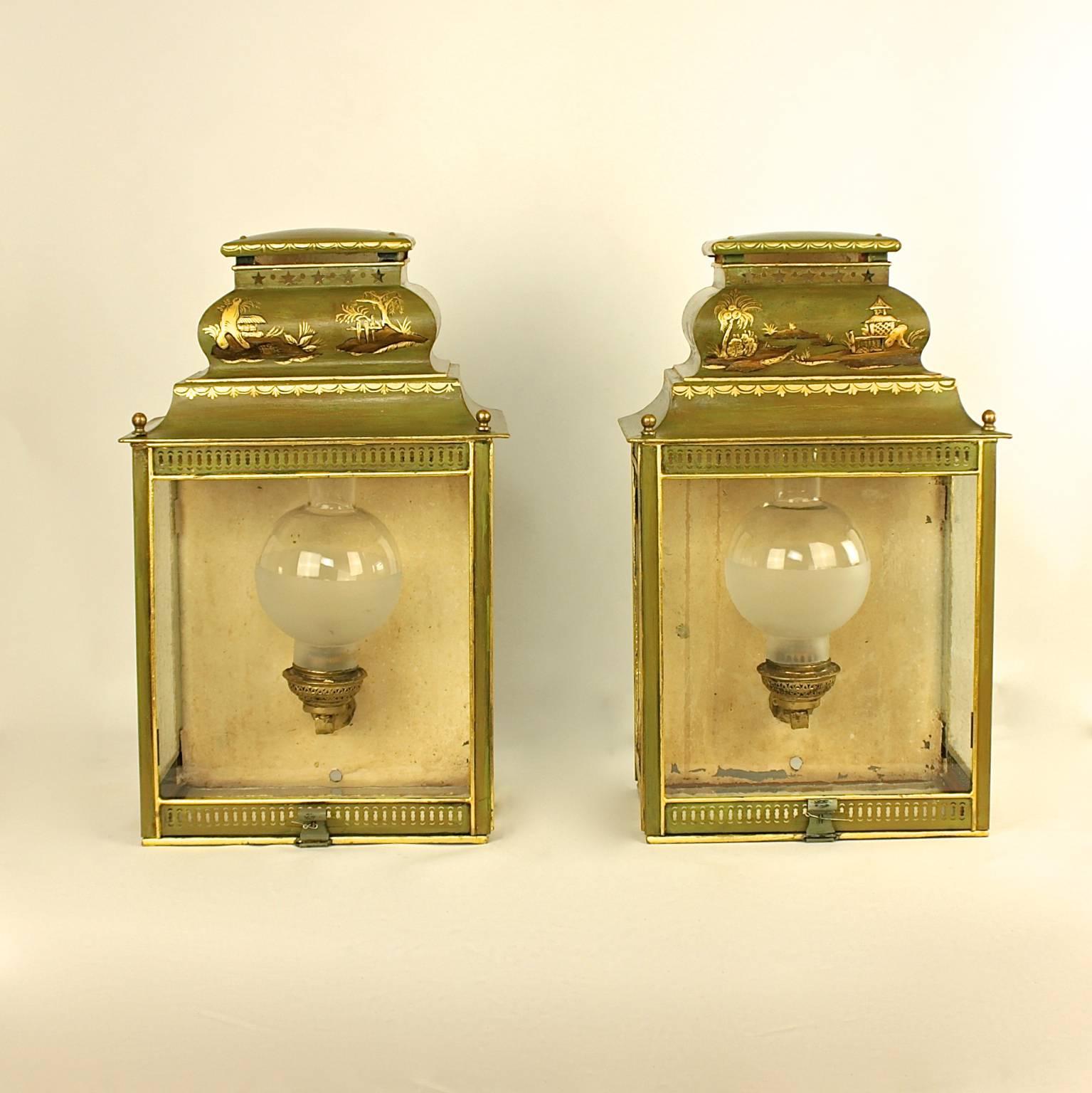 A Pair of green and gilt tole wall lanterns decorated with beautifully painted gilded Chinoiserie design of landscapes with palm trees, pagodas, rocks and flowers. Glazed panels on front, sides and bottom. Wired for Electricity.  