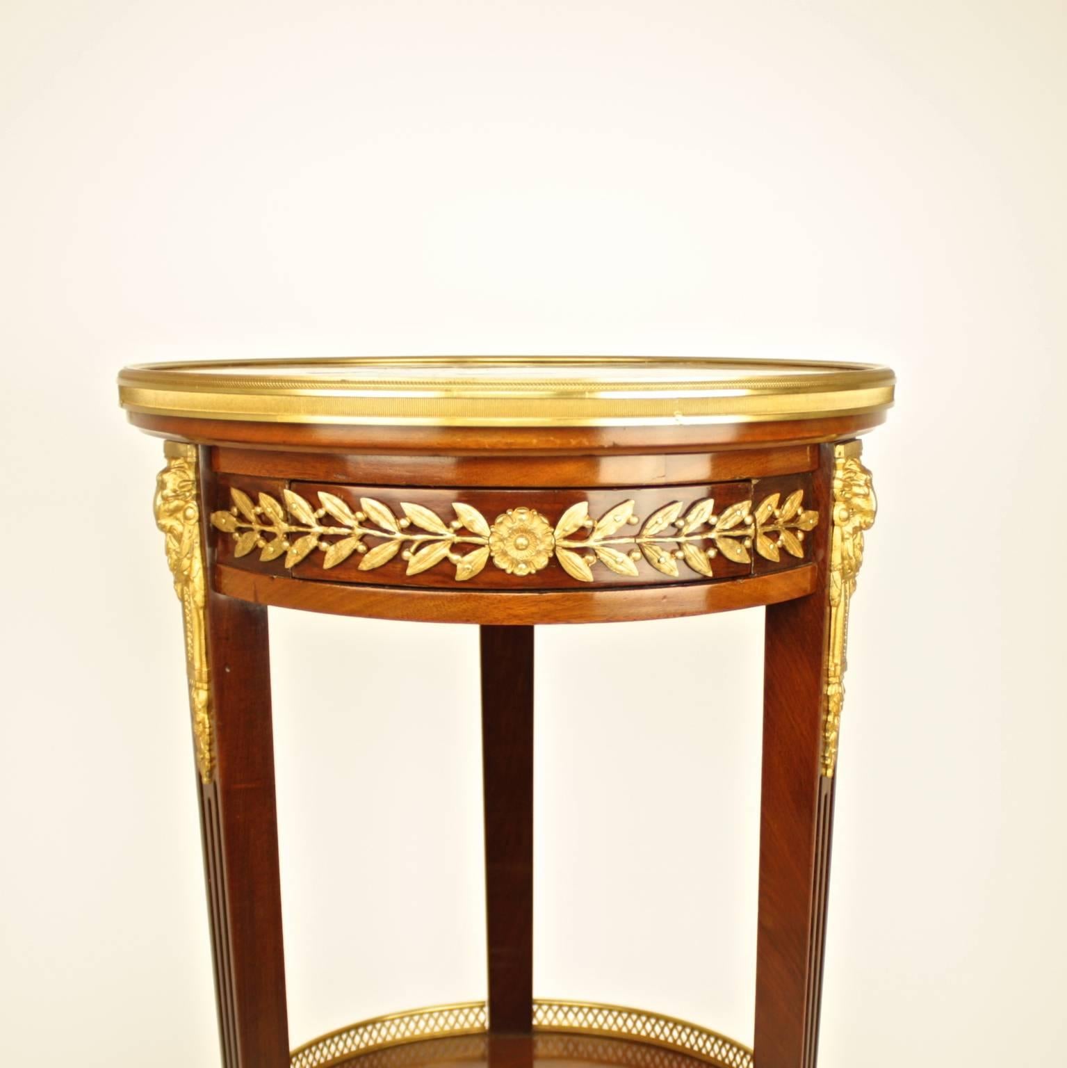 A fine pair of 19th century Louis XVI style gilt-bronze mounted two-tiered circular stand or guéridon, the circular breche d'alep red and ochre marble top framed by a pierced gilt bronze gallery above a gilt-bronze mounted frieze depicting paterae