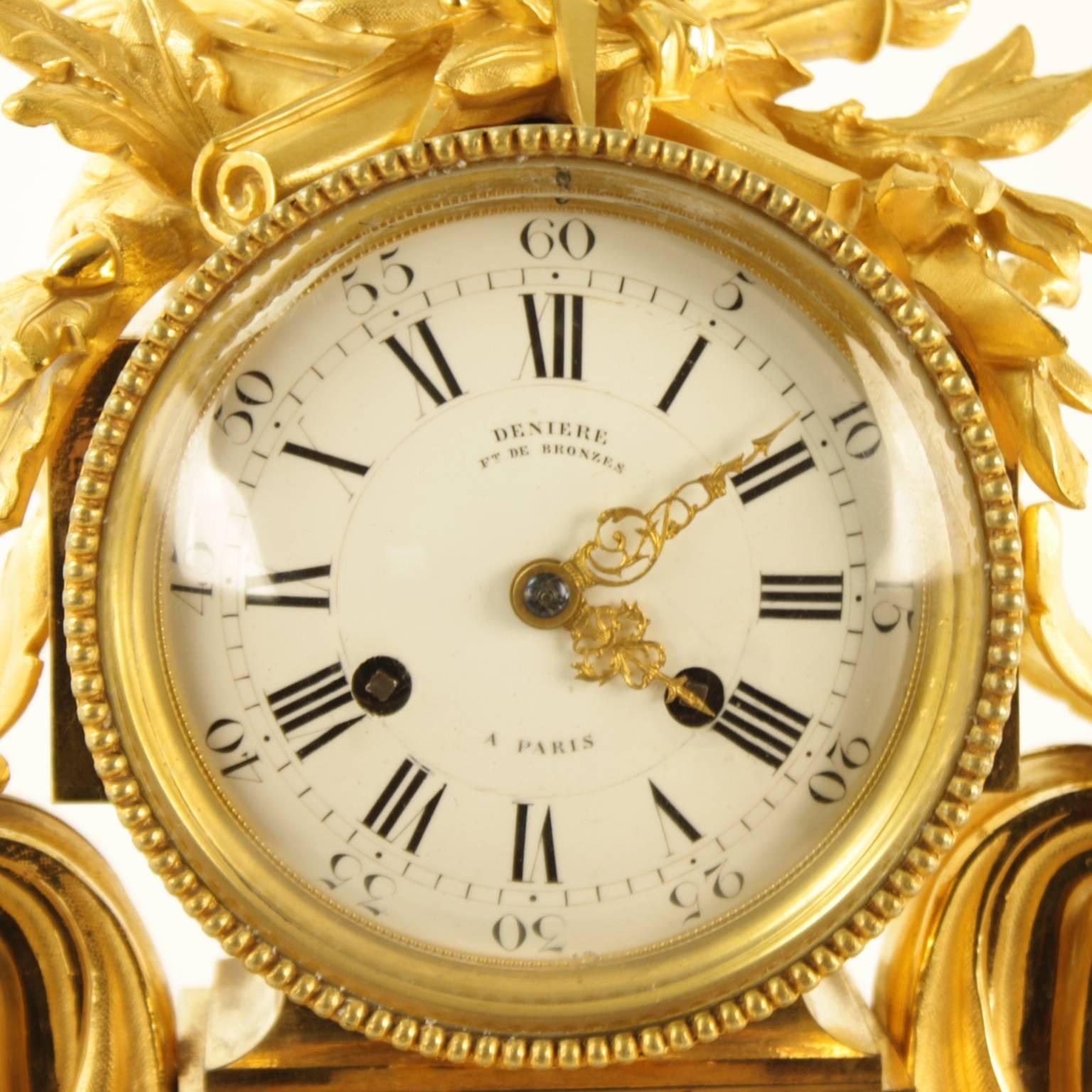 A large and impressive Louis XVI style ormolu mantel clock, the white enamel dial with Roman and Arabic numerals, surmounted by trophies of architecture, literature, music and war, flanked by acanthus leave corbels scrolling out as the dominant