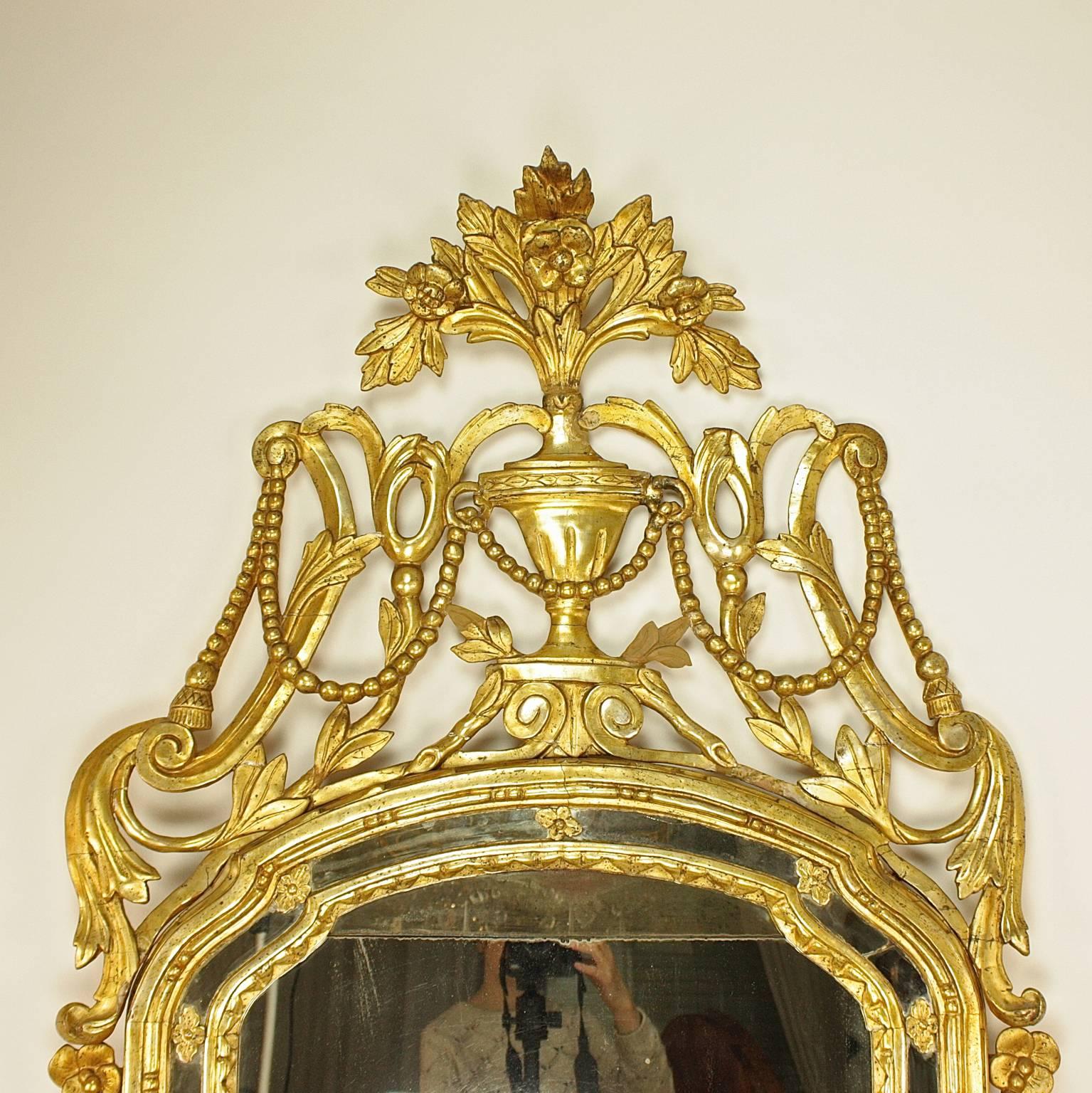 Large 18th Century Italian Rope & Tassels Decoration Carved Giltwood Mirror

A large and excellently carved and 18th century giltwood mirror with a shaped arched plate within a moulded frame and with a mirrored border. The elaborate pierced cresting
