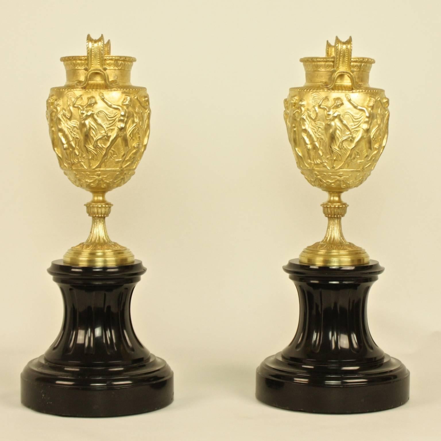 Pair of French Charles X Neoclassical Bacchanal Gilt Bronze Black Marble Urns or Vases

Pair of gilt bronze urns or vases, each with two volute handles inspired by Greek ancient volute-krater vases, the tapering ovoid body cast in high relief
