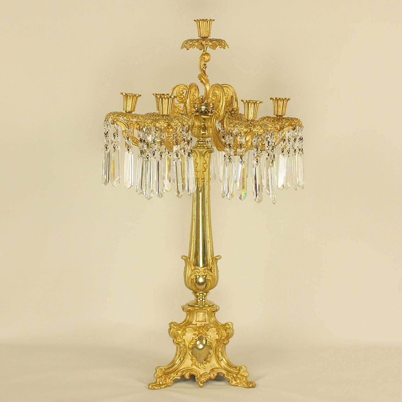 A pair of 19th century English gilt bronze cut-crystal candelabra each  stamped 'Abbott' on the underside of the base. Thomas Abbott was a designer, bronzier and lamp maker from Birmingham, active between 1830 and 1860. His workshop is known for its