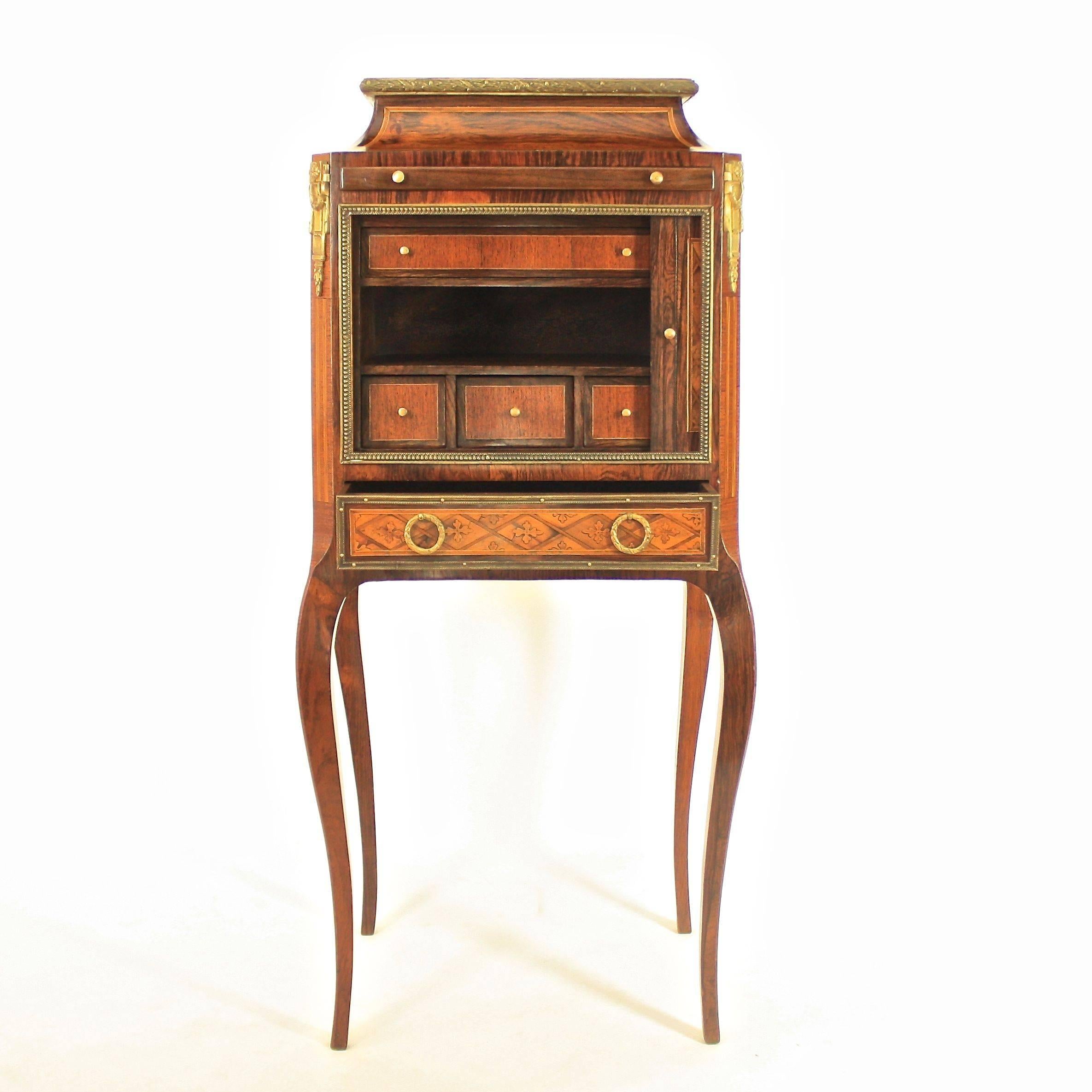 A small 19th century cabinet on Stand with a pagoda shaped top and a sliding door compartment containing three small drawers, one long drawer and a shelf, supported by four slender cabriole legs. The oak carcase veneered with 'marqueterie à la