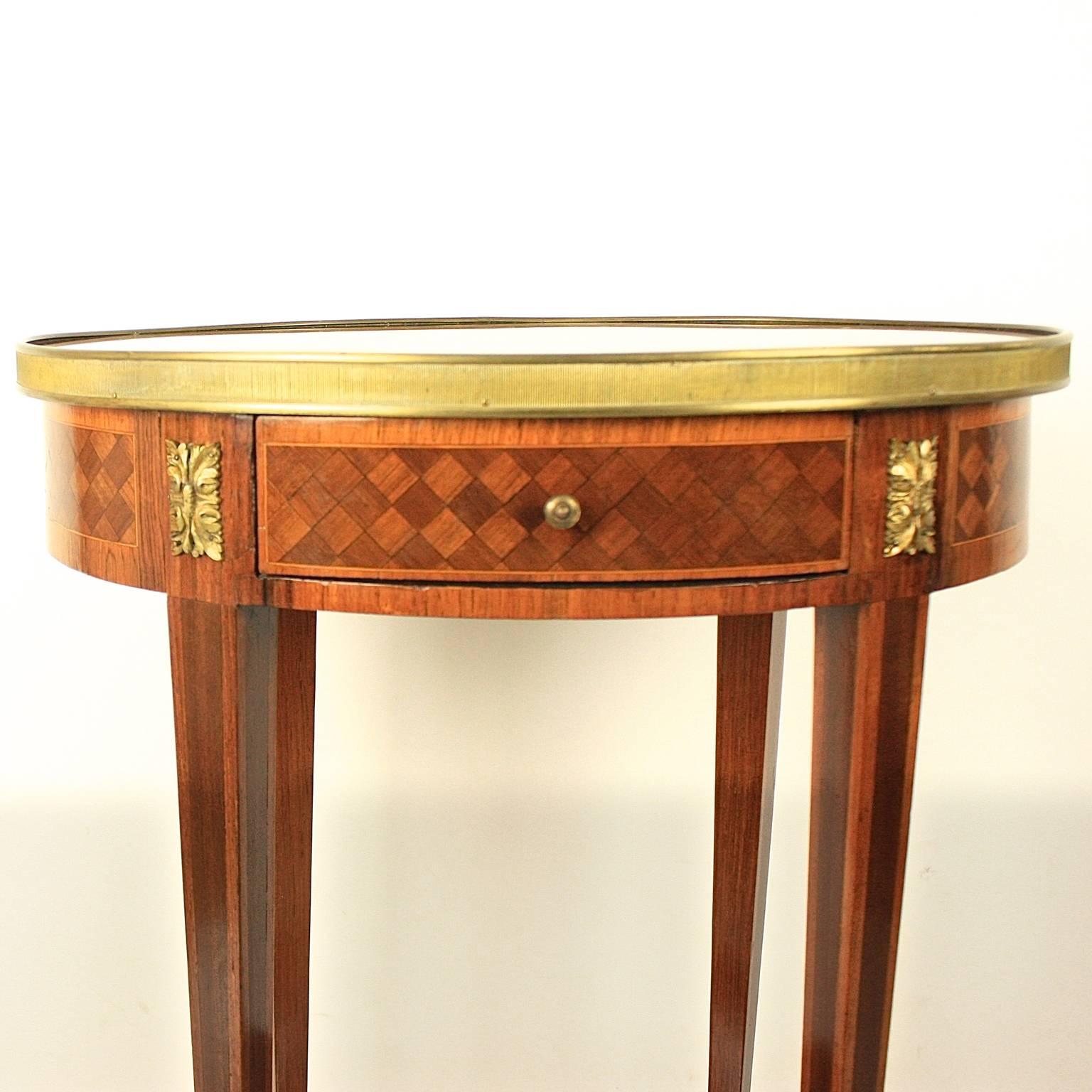 A small 19th century bronze-mounted marquetry side table of oval shape, with a breccia marble top in deep burgundy red and greyish white, surrounded by a 'Mille Raie' gallery above one frieze drawer with cube marquetry, joined by a conforming
