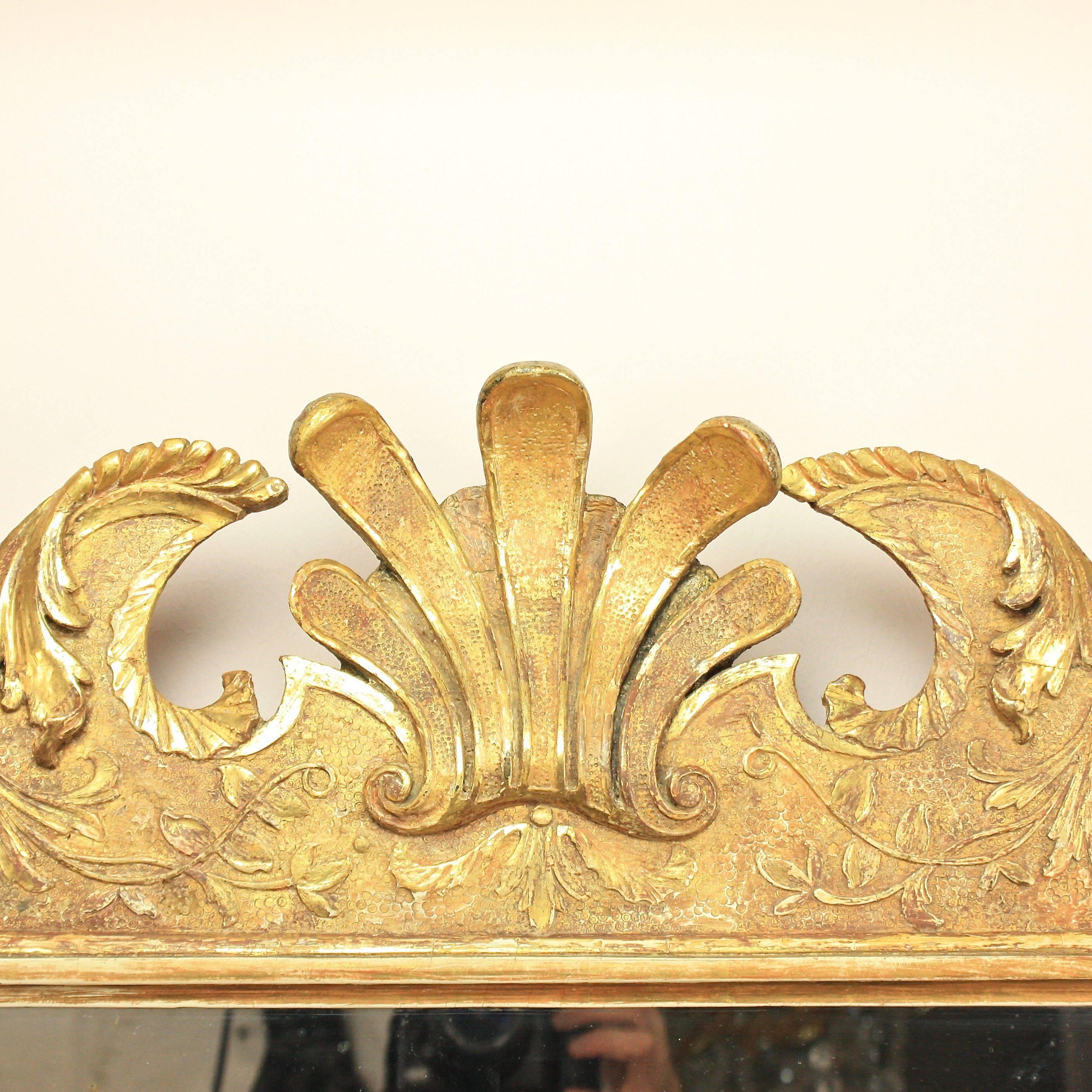 Early 18th century George I giltwood pier mirror in the manner of James Moore (circa 1670-October 1726) and John Gumley (circa 1670–19 December 1728). A mirror similar in design and seize is currently on display at Beningbrough Hall, North