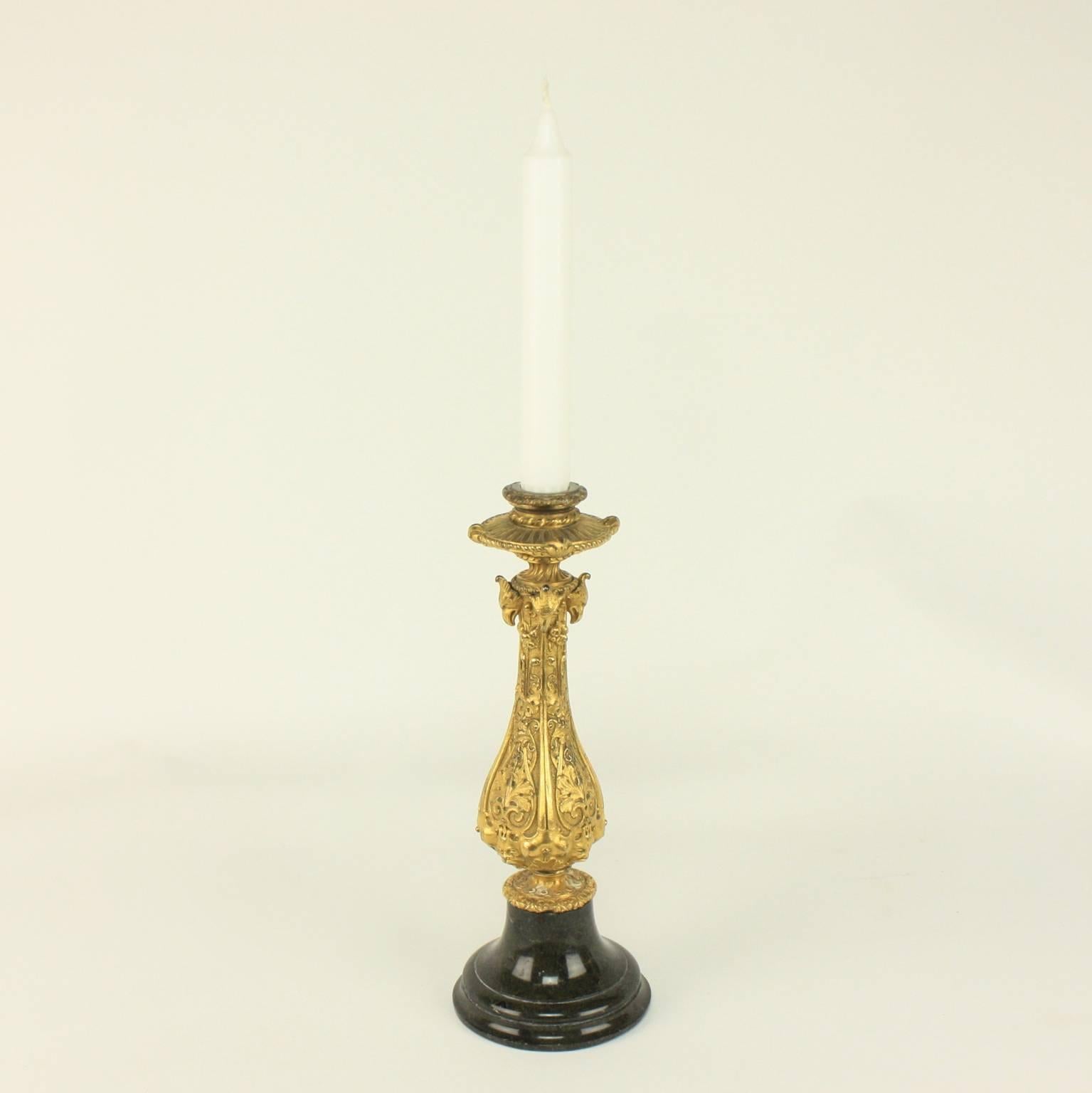 A 19th century Renaissance Revival gilt bronze candlestick on a Belgium black marble base. The socket rests on a four-sided baluster stem; each chased with elongated female-headed birds, so-called harpies, grotesque masks, strap work and acanthus