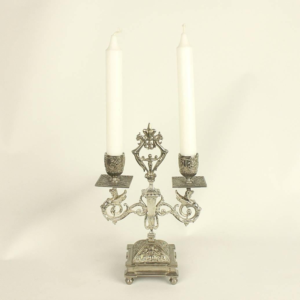 A pair of silver plated Renaissance Revival two-light candelabra by Alphonse Giroux (1809-1886). His Paris workshop was known for its fine and high quality ormolu bronzes and miniature furniture. Here an example that is silver plated with intricate