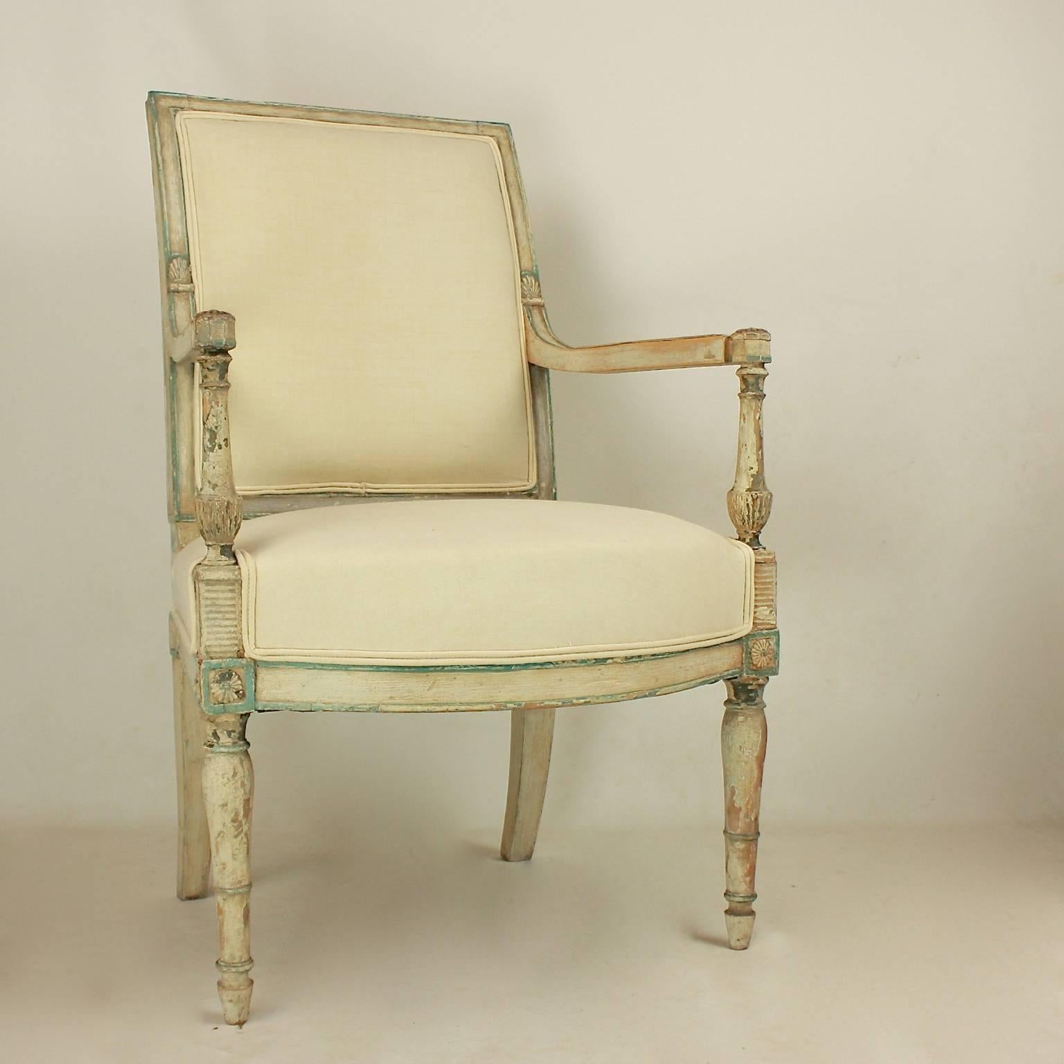 A pair of paint wood armchairs or Fauteuils 'a' l'E´trusque', in the manner of Henri Jacob (1753-1824, maitre, 1779), with a rectangular plat back, its top wrapped, with flat armrests with rosettes supported by balustrades that are connected with
