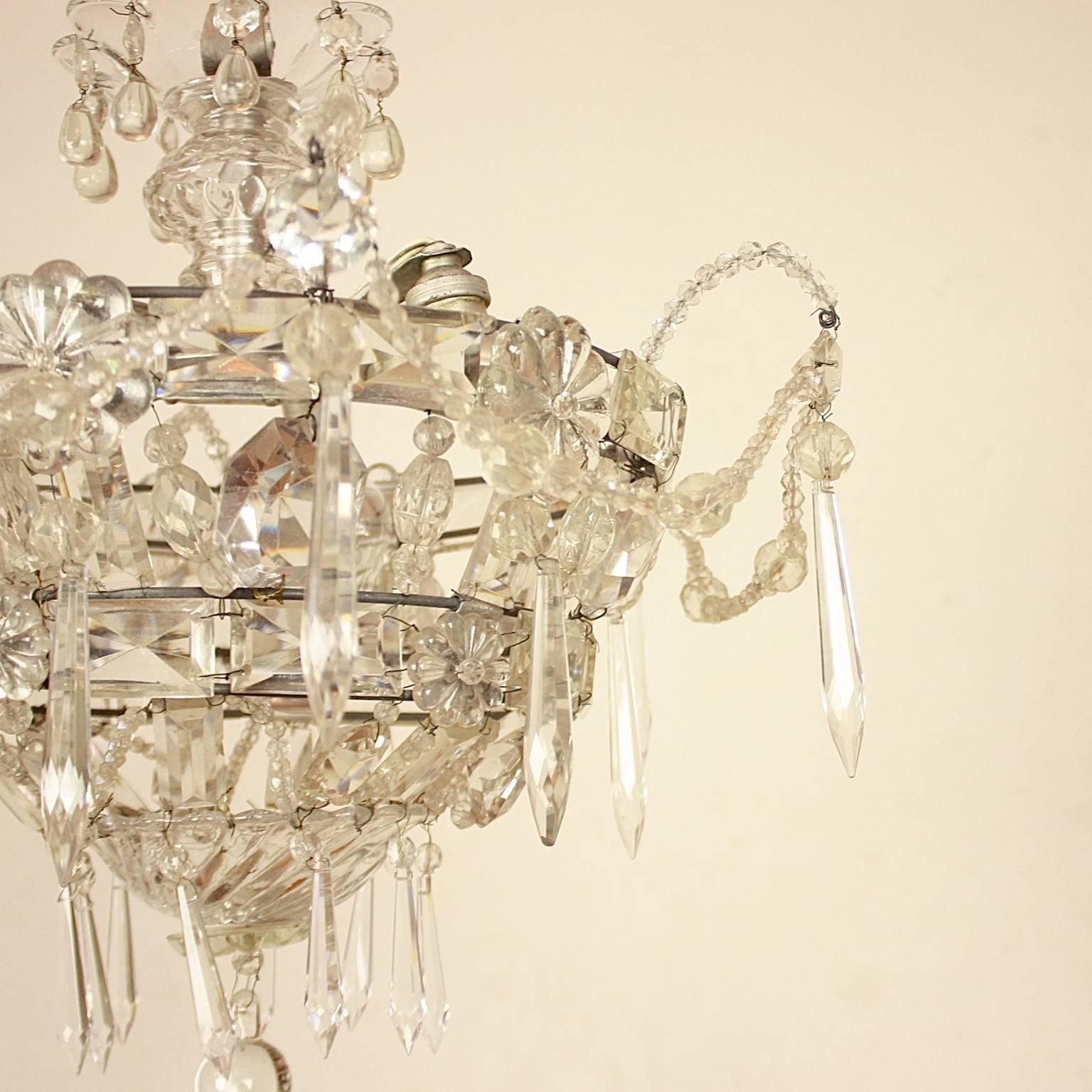 Unique circular ceiling lamp or plafonière. From a ceiling glass rosette a two tier basket-formed corpus is hang with cut crystal prism and terminating in a solid glass ball. The whole beautifully adorned with cut crystal drops, prisms, flower