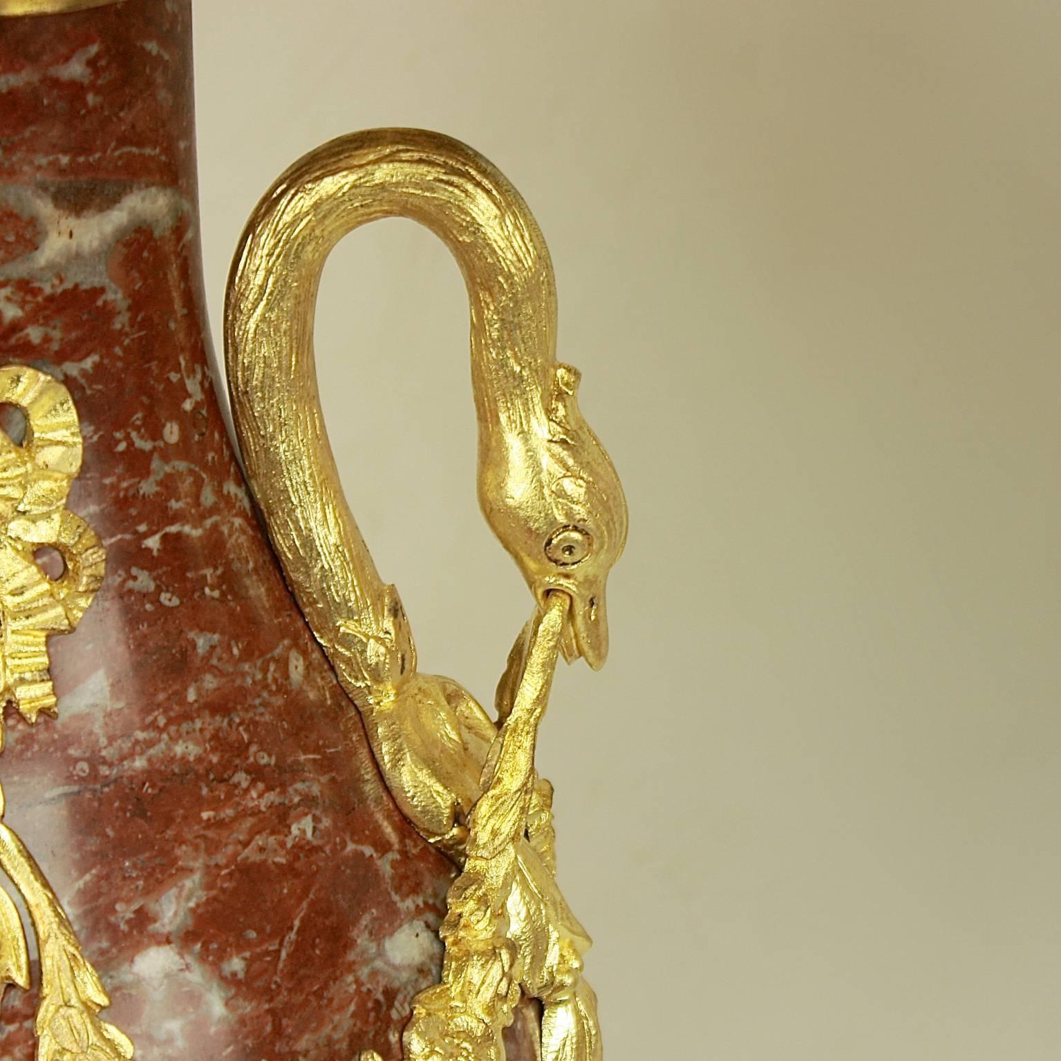 Pair of 19th century Louis XVI style solid 'royal rouge' marble and gilt bronze-mounted baluster-shaped table lamps. The finely chiseled and well-proportioned gilt bronze applications decorated with detailed ornamentation. Attached to the narrow