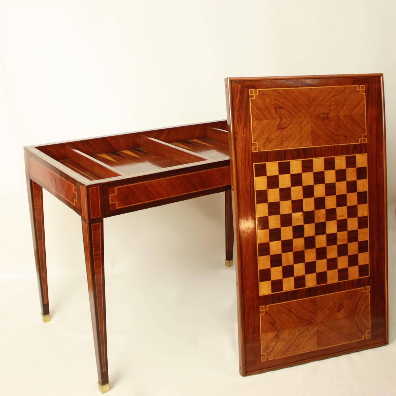 A 19th century tric trac game table, the rectangular top removable, inlaid on one side with a chess board, on the other with a simple banding around a vivid walnut veneer - ideal for a card game. Removing the top reveals a tric trac board, tric trac