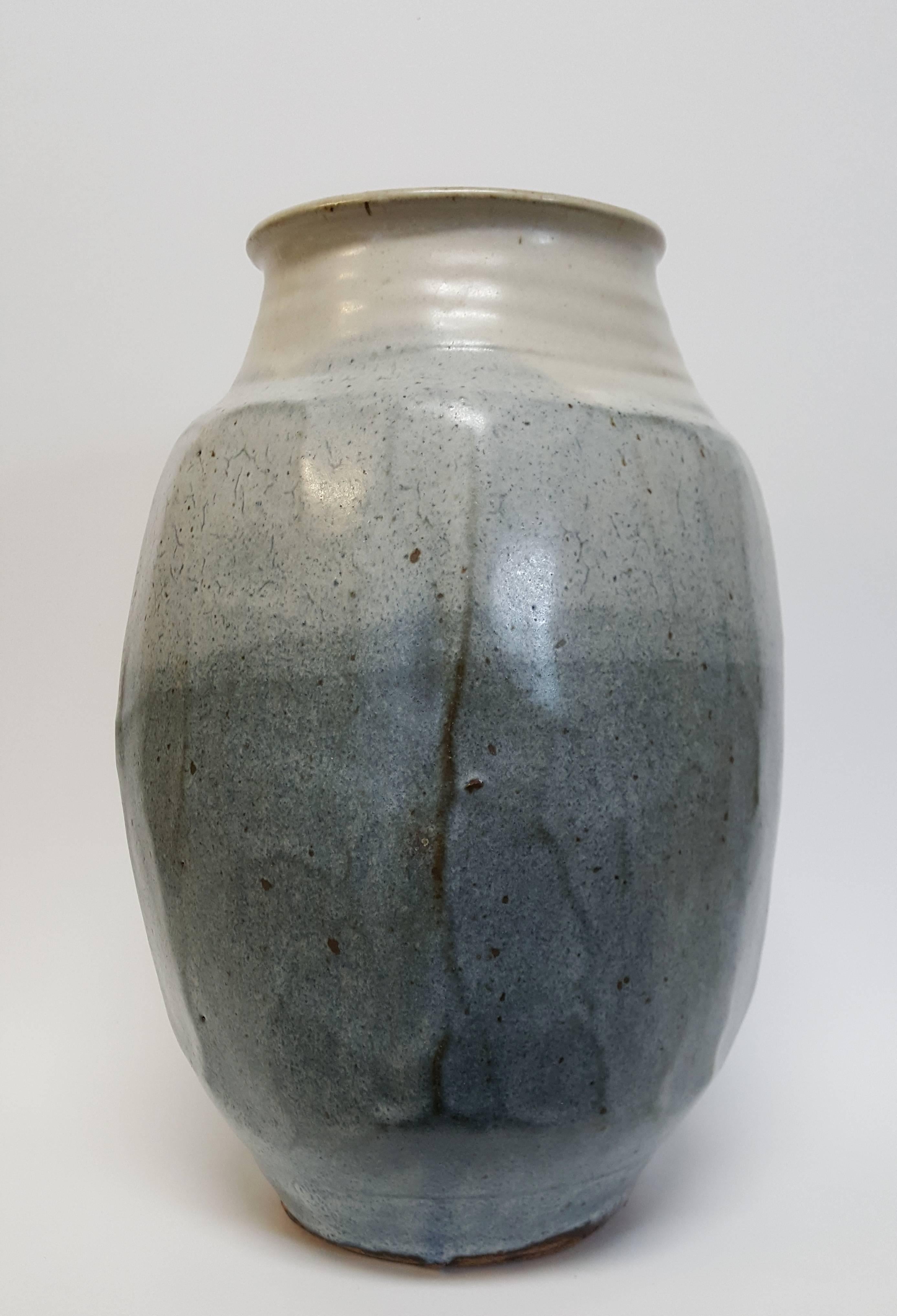 Warren Mackenzie (born 1924)
Large Four Sided Blue Vase, n.d.
Stoneware
Measures: 11 ½ x 7 x 7 inches
Artist’s stamp at base: M.


Mackenzie's defining moment leading to his life's work began while he was a student at the Art Institute of