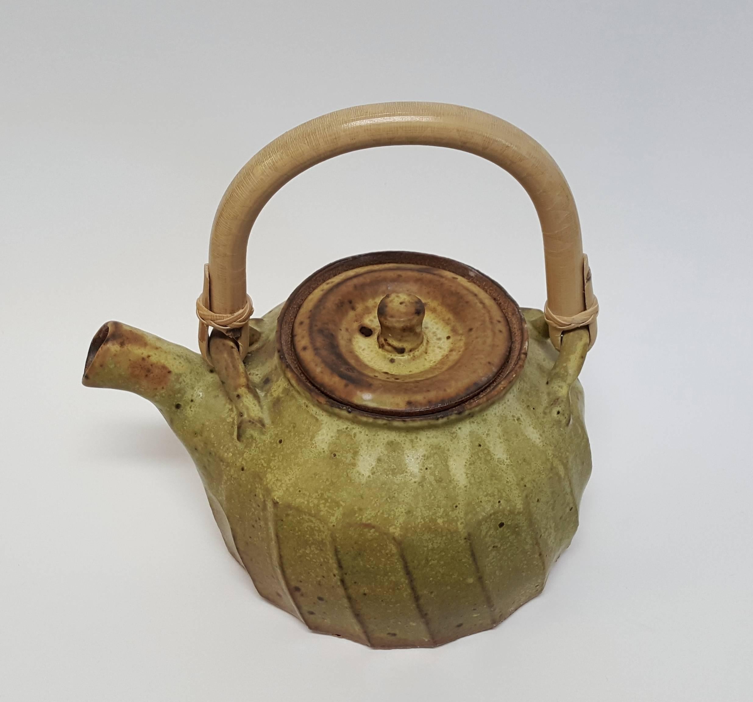 Warren Mackenzie (born 1924)
Fluted Teapot, n.d.
Stoneware
Measures: 4 x 5 inches


MacKenzie's defining moment leading to his life's work began while he was a student at The Art Institute of Chicago when he came across a simple and practical