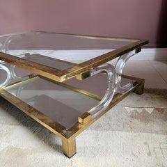 Hollywood Regency brass and lucite coffee table. Attributed to Maison Jansen