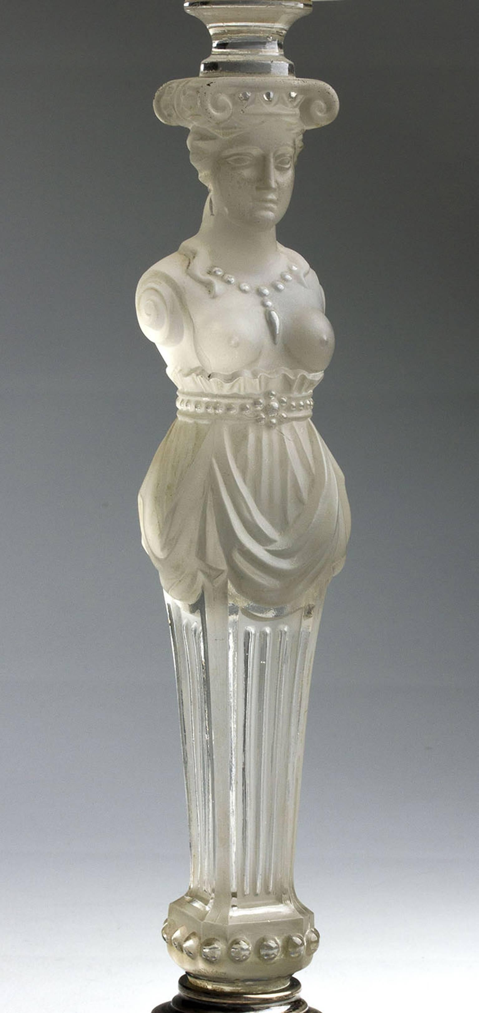 A Baccarat etched crystal and solid silver circular base figural centrepiece featuring a standing caryatid supporting a crystal bowl with a central trumpet vase. Very clear hallmarks struck to the surface of the base, Holland, 1869. Dimension: