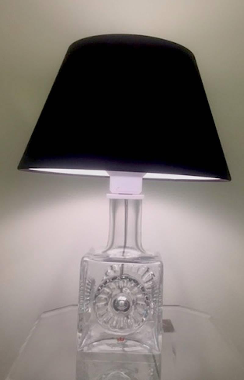 A 1960s modern lead crystal table lamp by Kosta Boda of Sweden. Square base with central round medallion design in the crystal. Original Kosta Boda signature sticker. New shade and rewired. The table lamp base 4.5