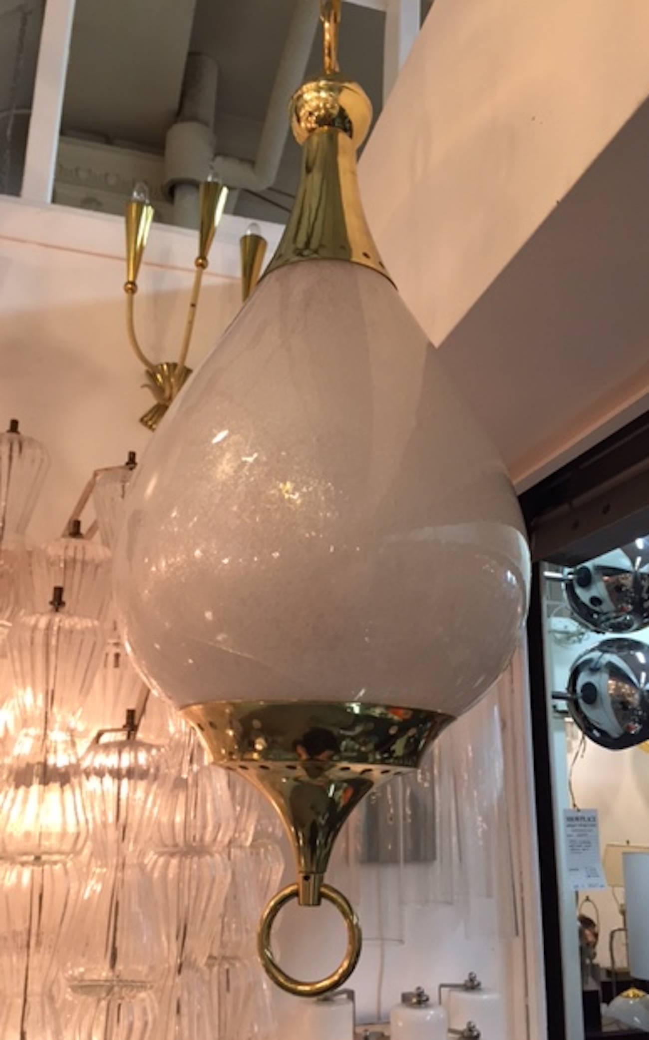 A lovely 1950s drop shape pendant light. The shade is handblown Pulegoso glass. Pulegoso is Italian for many bubbles. The top and bottom mounts are beautifully made with a pierced dot boarder for light to shine through as well matching decorative