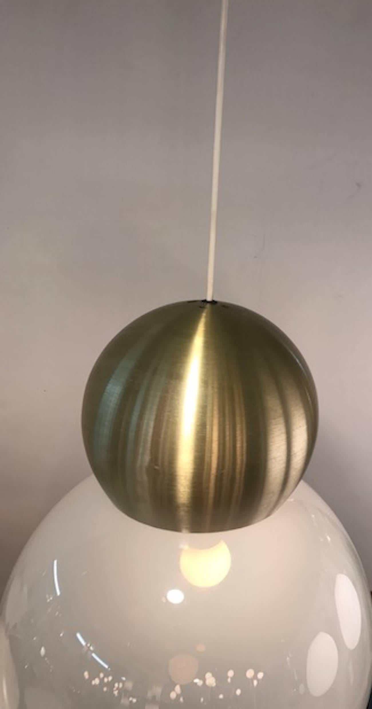 A 1970s modern design pendant light by well-known Italian lighting company Stilux of Milano. The white opaline shade is handblown and measures 13