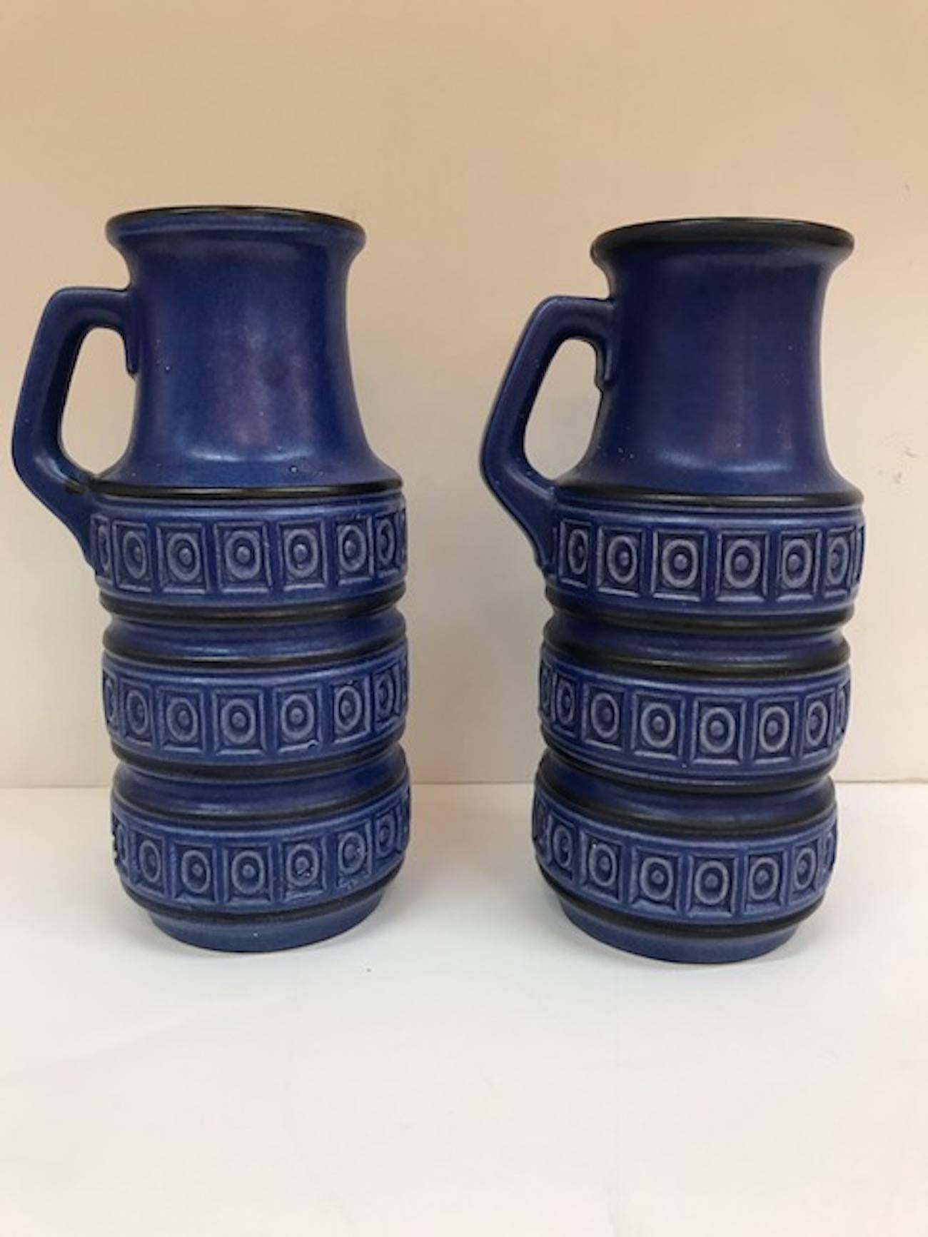 A lovely pair of matching matte finish indigo blue ceramic jug vases by prolific West German ceramic company Scheurich. Each jug 6 inches at the widest point including the handle, 4