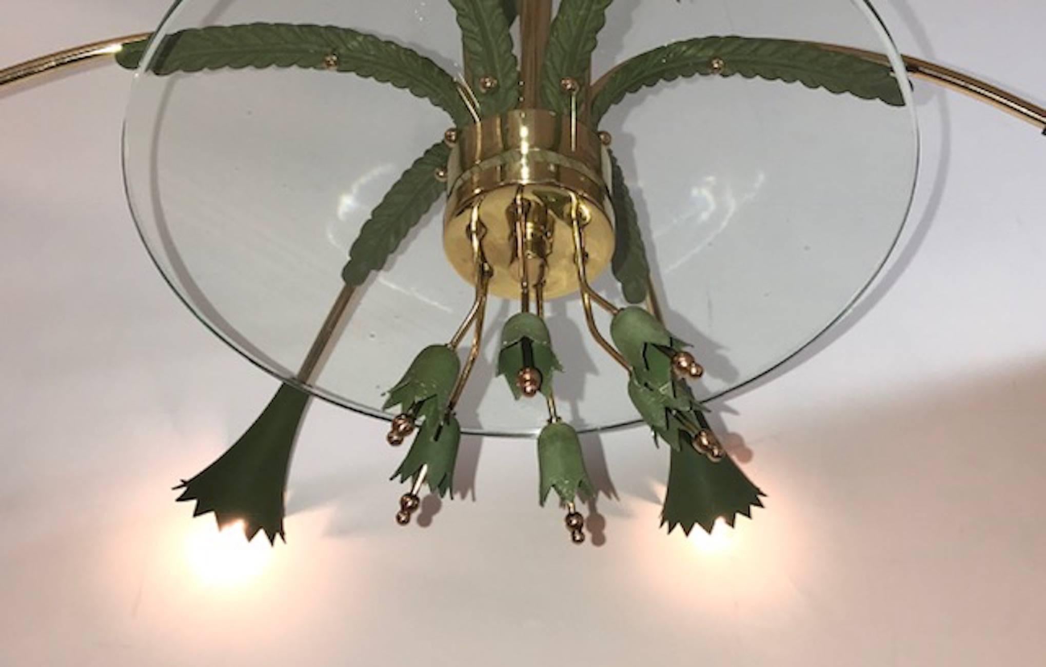 A charming Italian floral theme chandelier from the late 1940s to mid-1950s in brass and green enamel with large glass plate.
Holds six candelabra sockets.